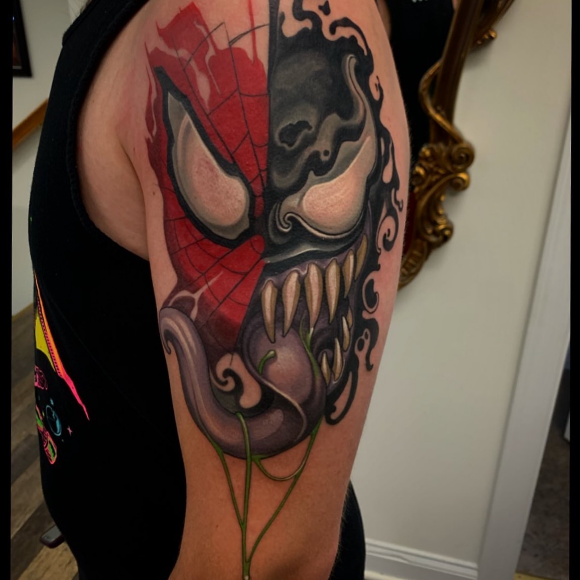 Venom mask dark realism tattoo on the upper arm by John Tarrao, Berwyn, Pennsylvania