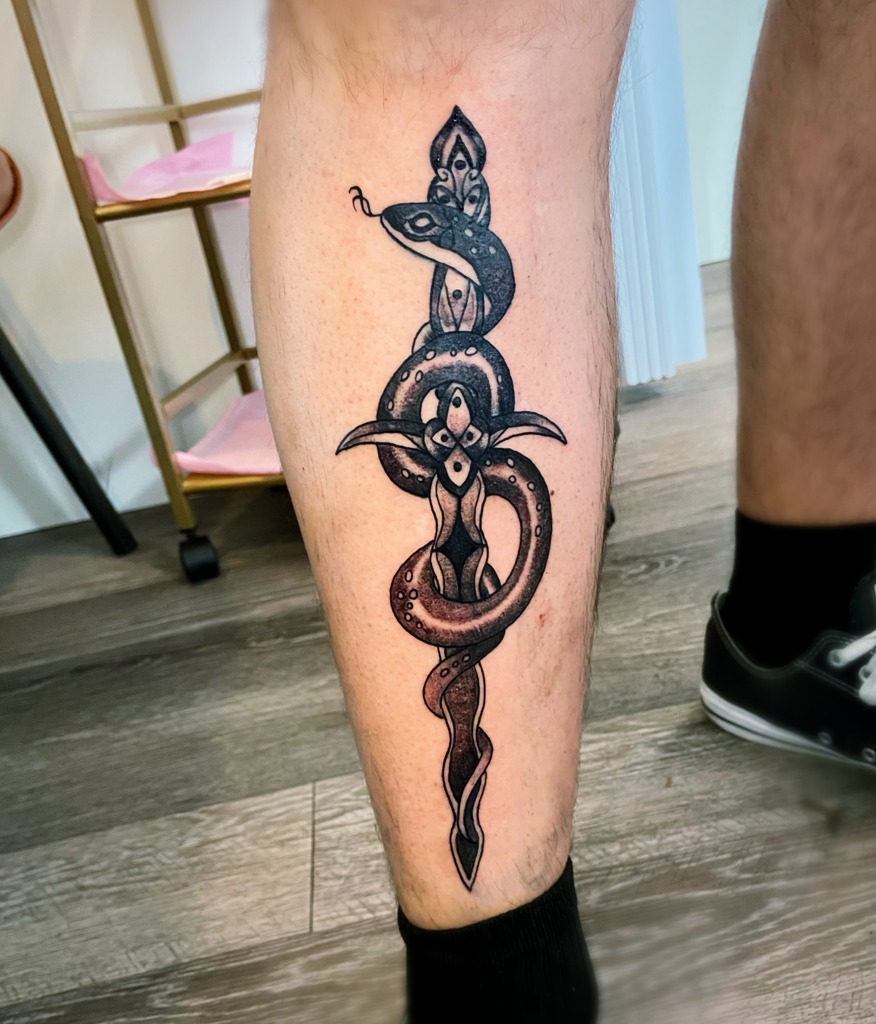 Snake black and grey tattoo on the calf by Shay Cole