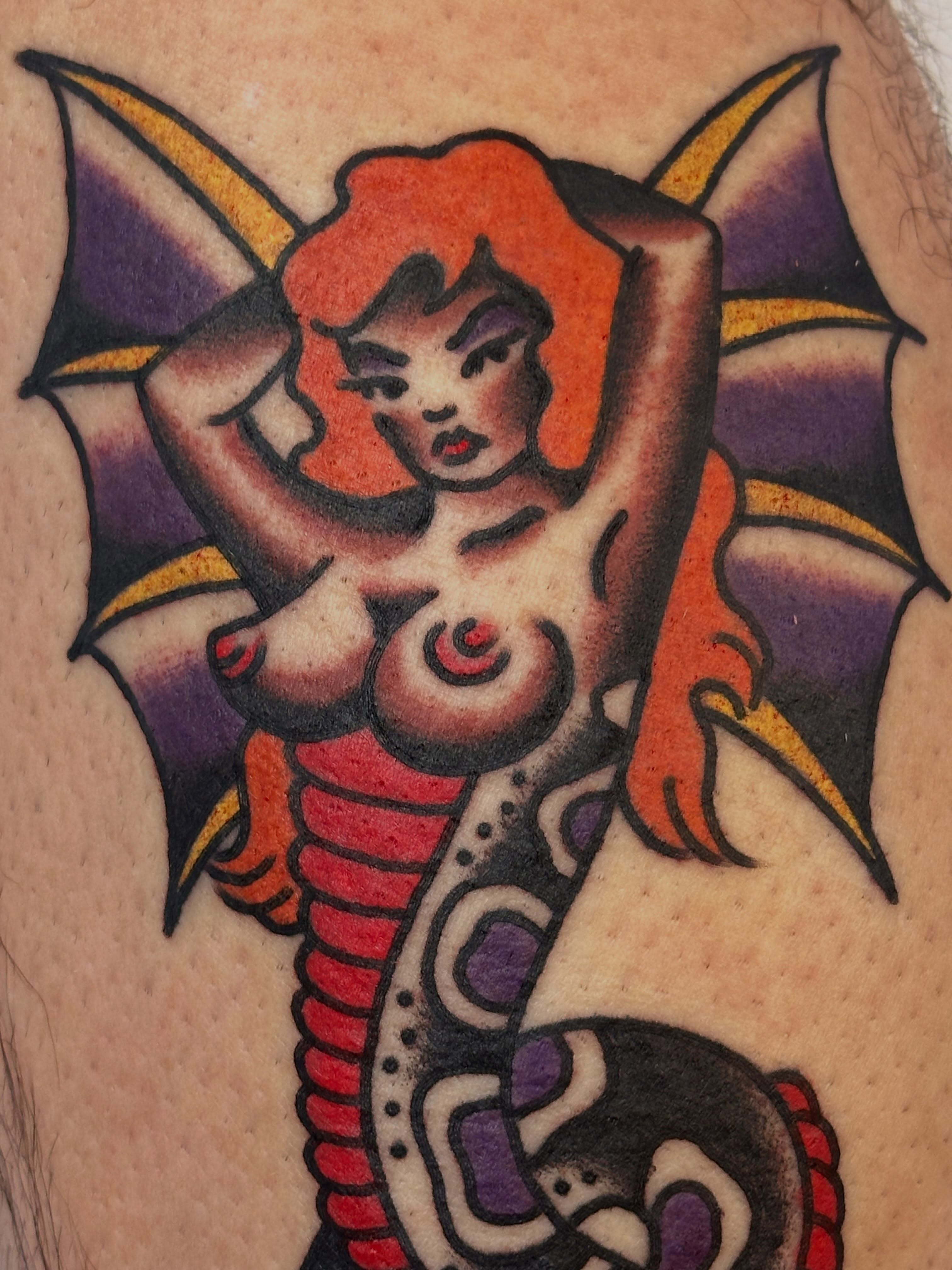 Woman with wings American traditional tattoo on the upper arm by Cody Woolard, Seymour, Tennessee