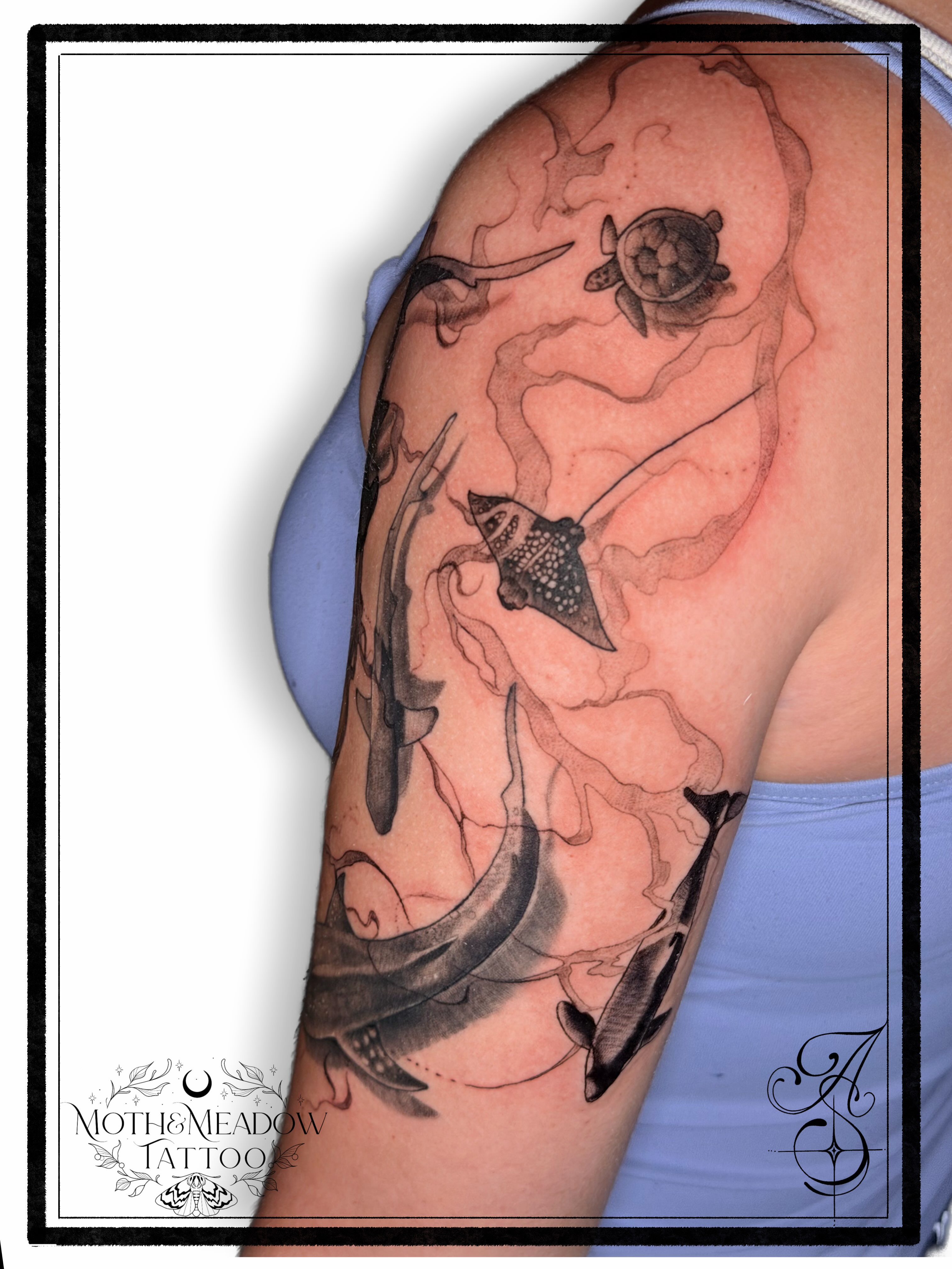Sea creatures realism tattoo on the upper arm by Ash Sansoucie
