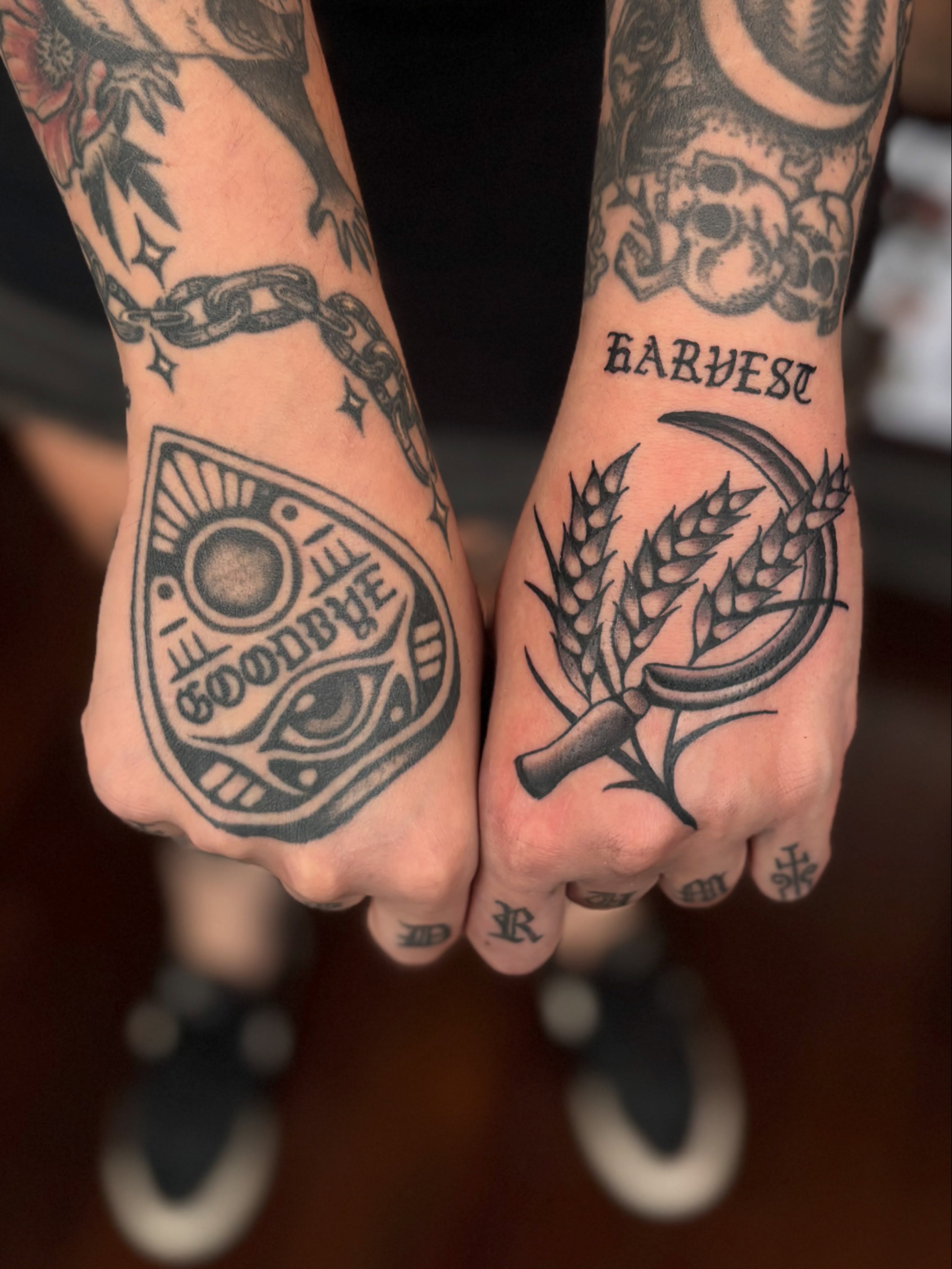Wheat sheaf and sickle black and grey tattoo on the hand by Jesse Smith, Chicago, Illinois