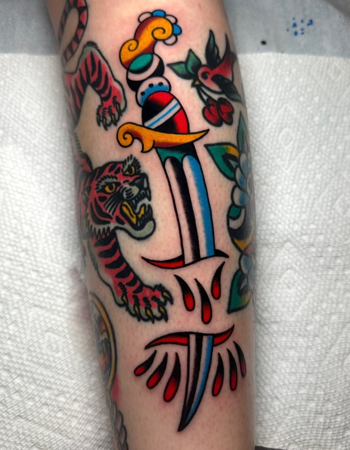 Tiger and dagger American traditional tattoo on the forearm by Zahra Niedermann