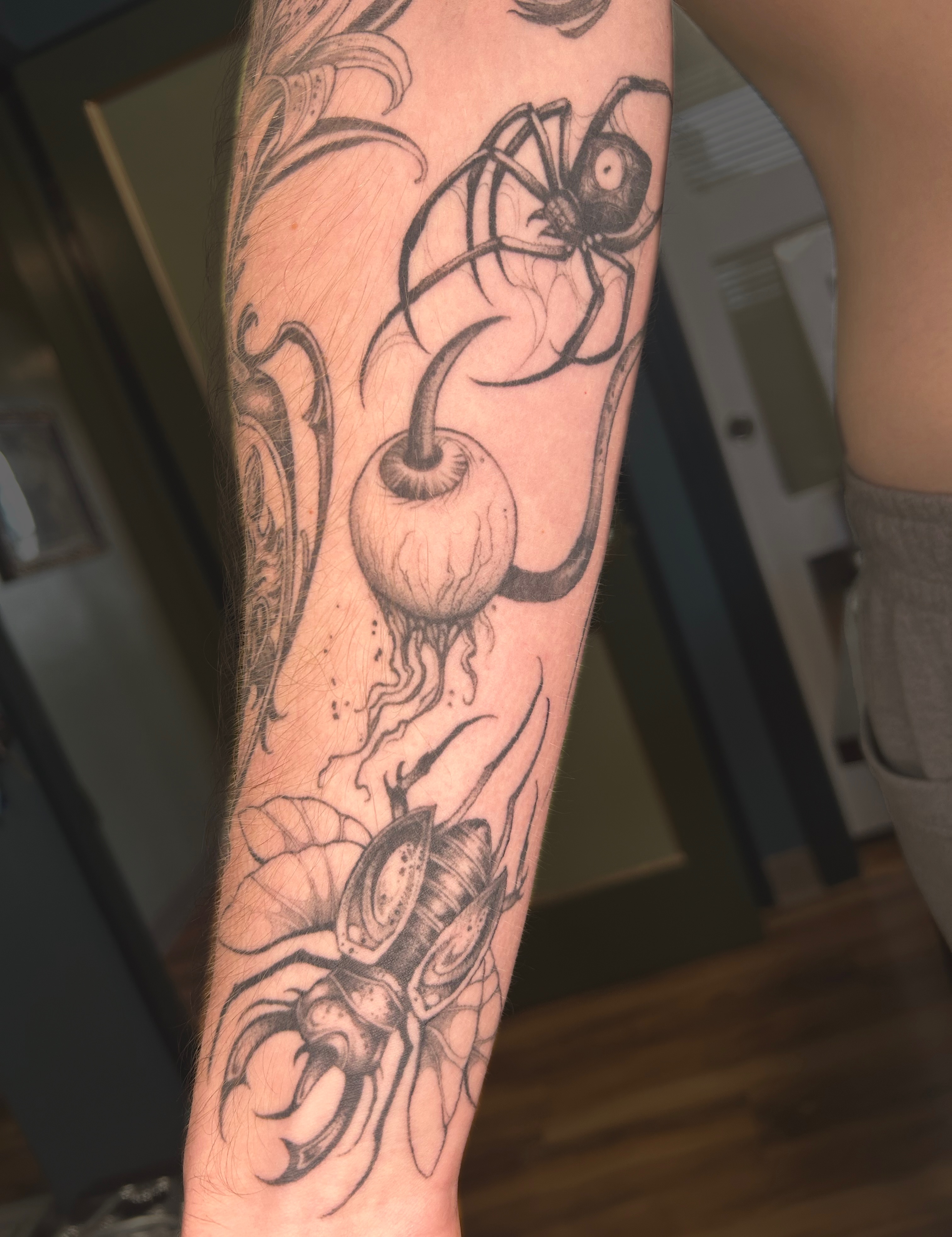 Cherry and spider black and grey tattoo on the forearm by Magnus