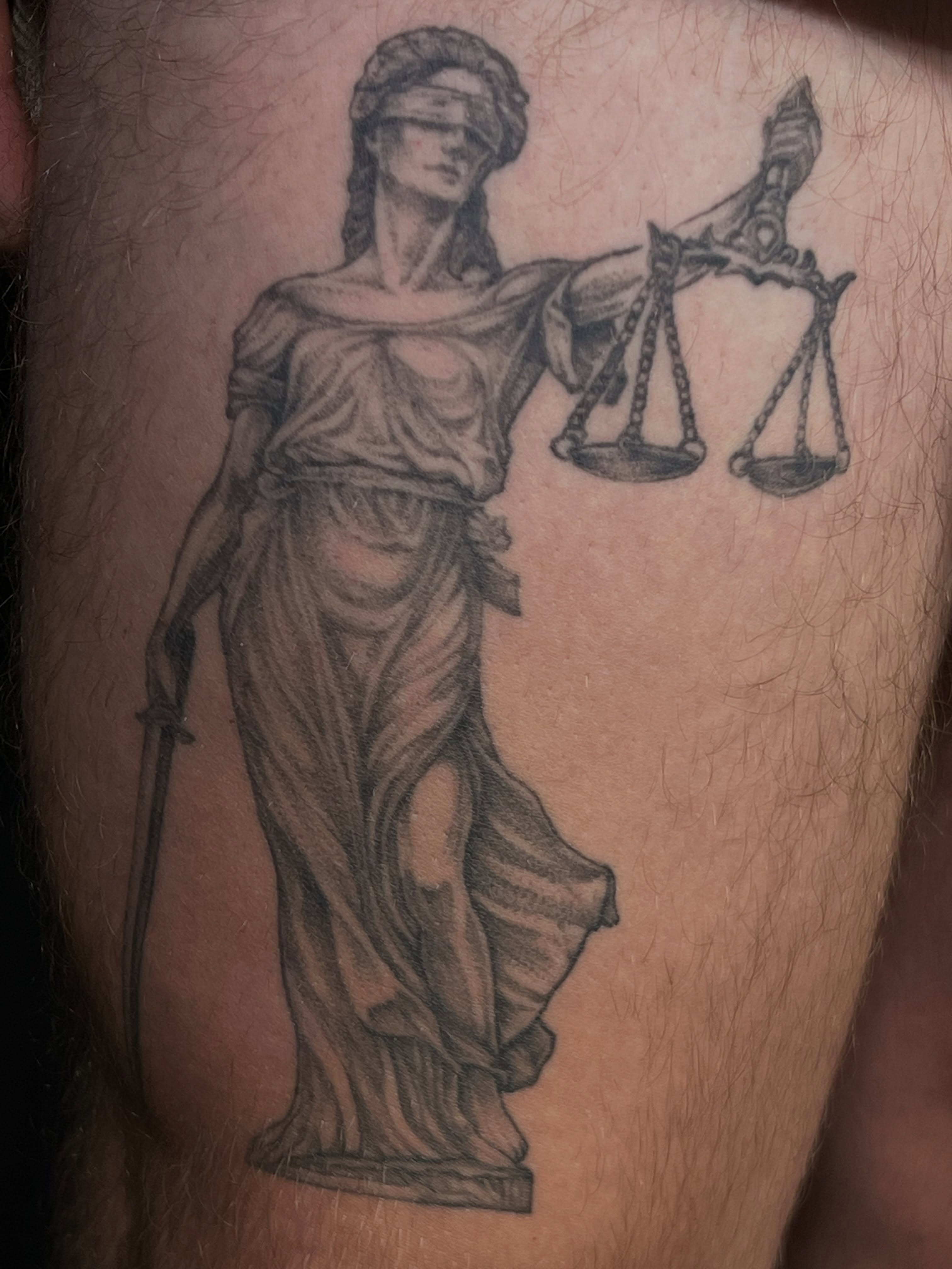Statue of justice black and grey tattoo on the thigh by Simón, Newington, Connecticut