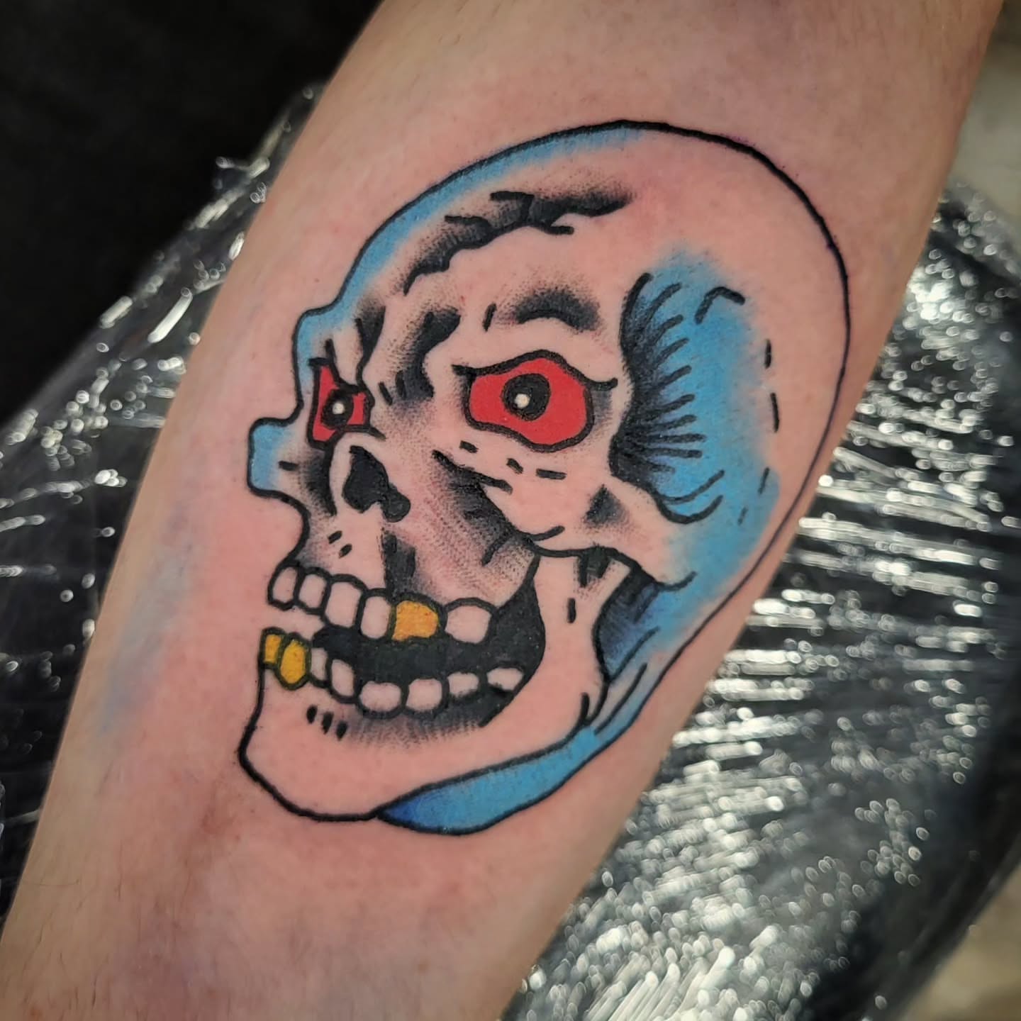 Skull American traditional tattoo on the forearm by Sloan Smith