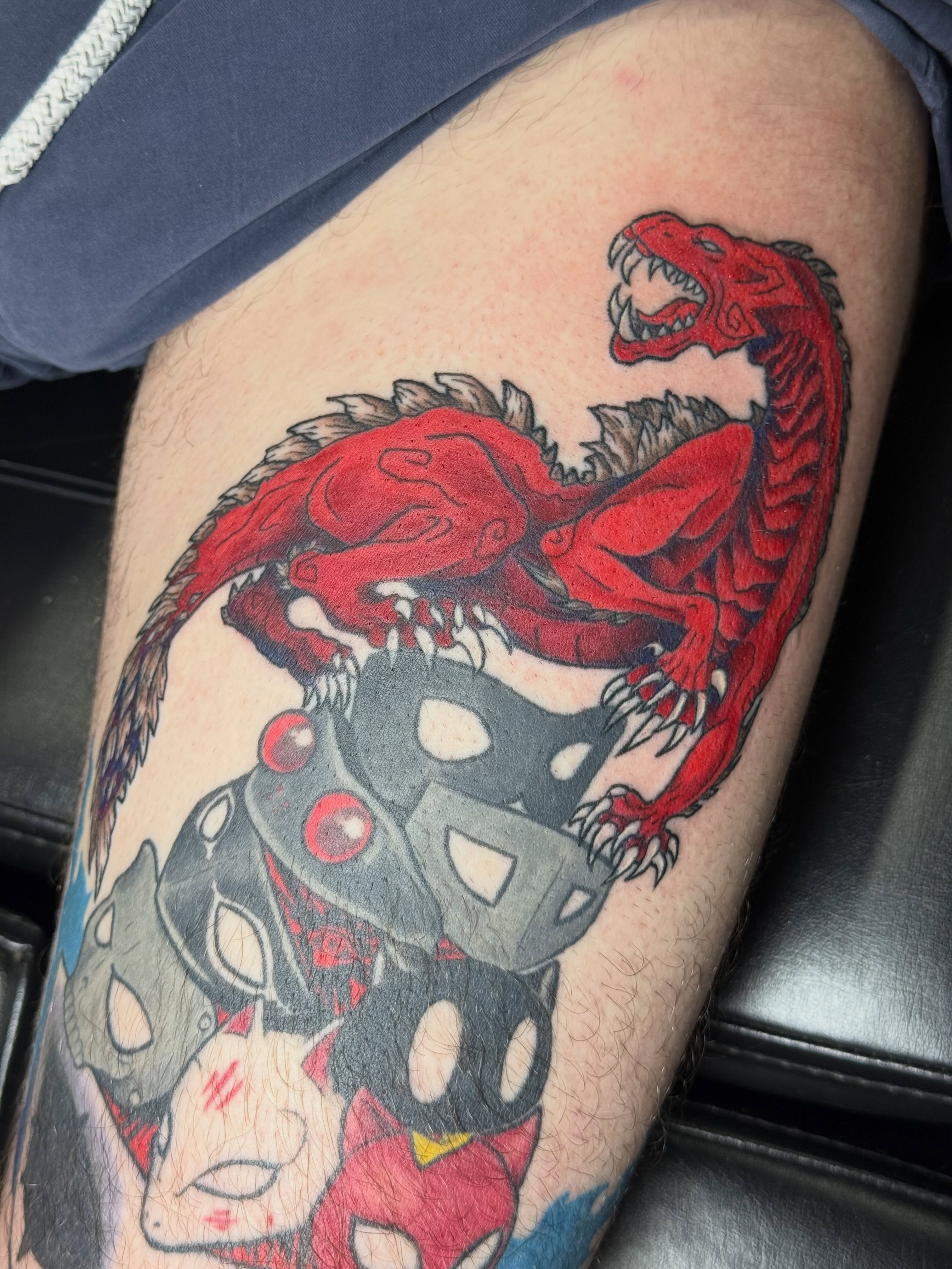 Dinosaur and robot American traditional tattoo on the thigh by Camryn Justice