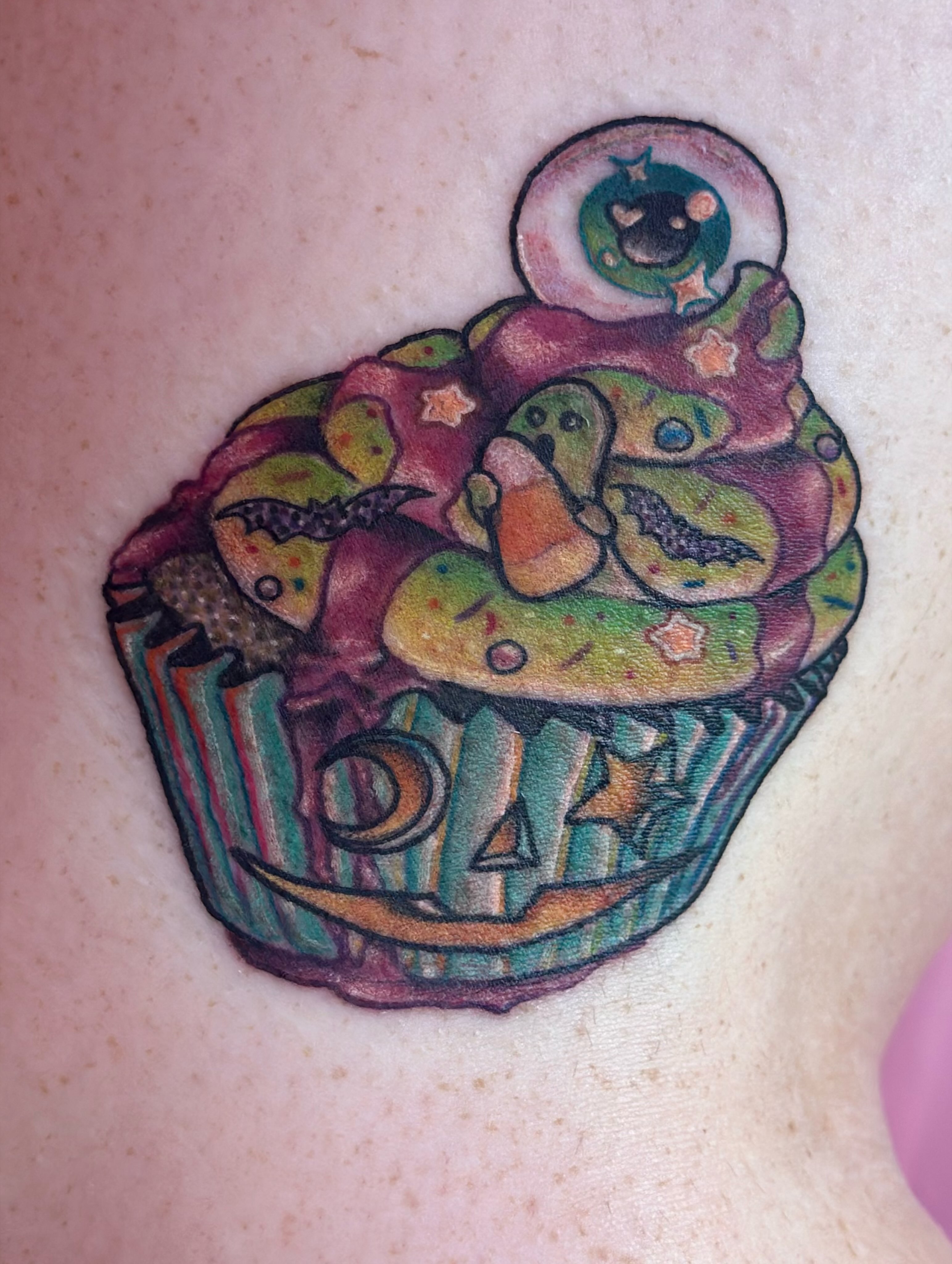 Cupcake new school tattoo on the torso by Erin Miller