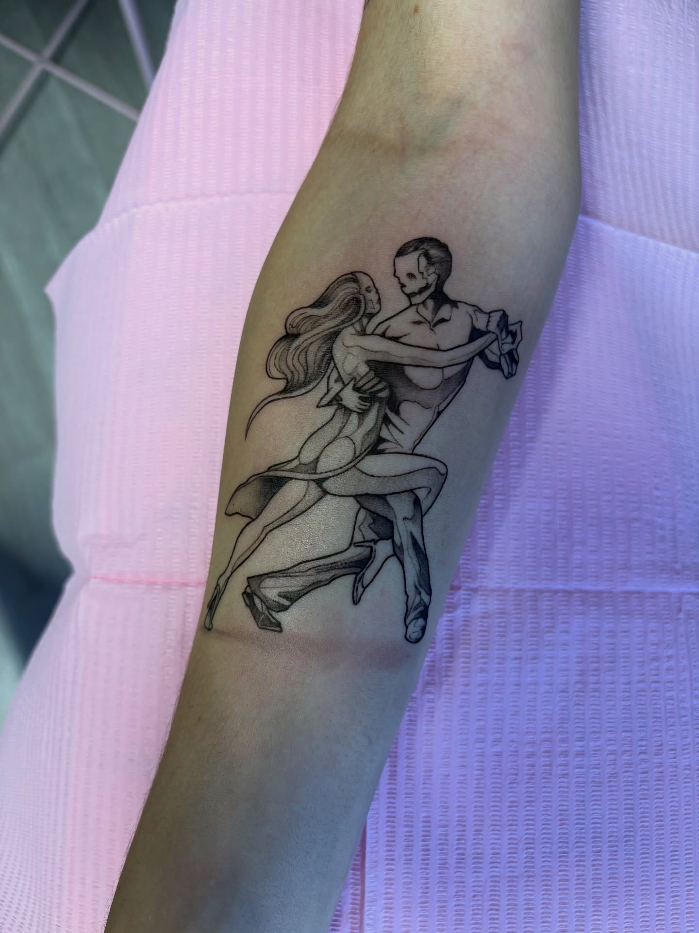 Dancing couple black and grey tattoo on the forearm by Elixabeth
