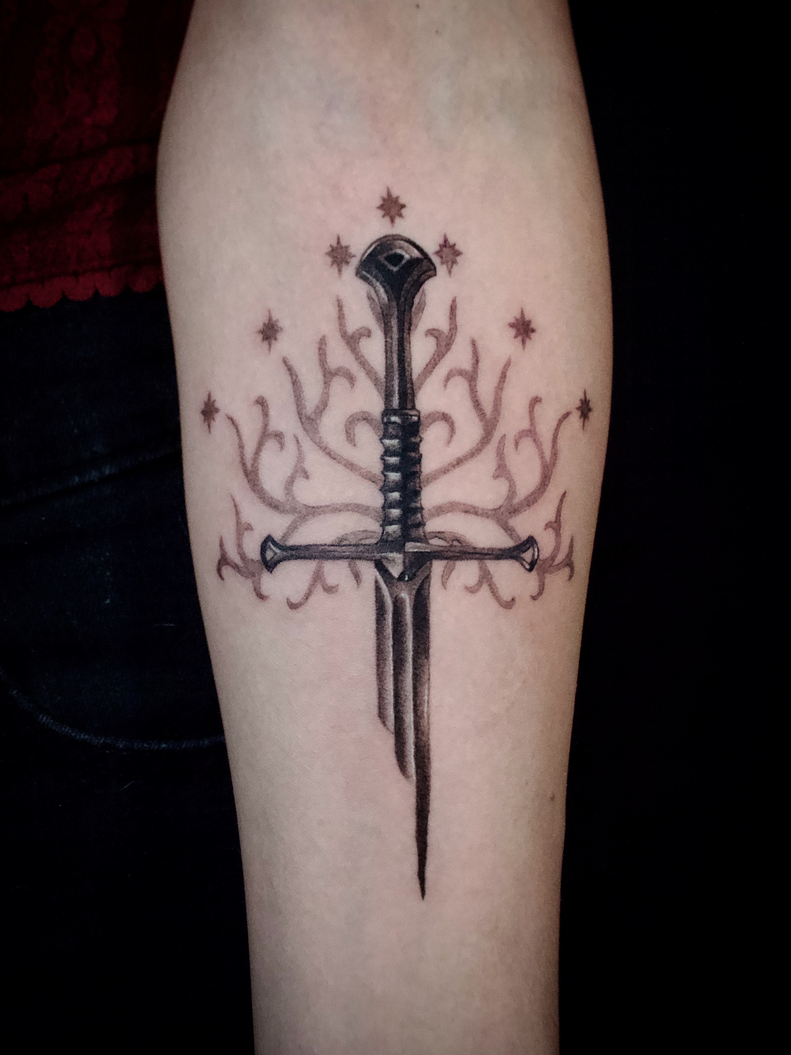 Sword and antlers black and grey tattoo on the forearm by Kanya, Alhambra, California