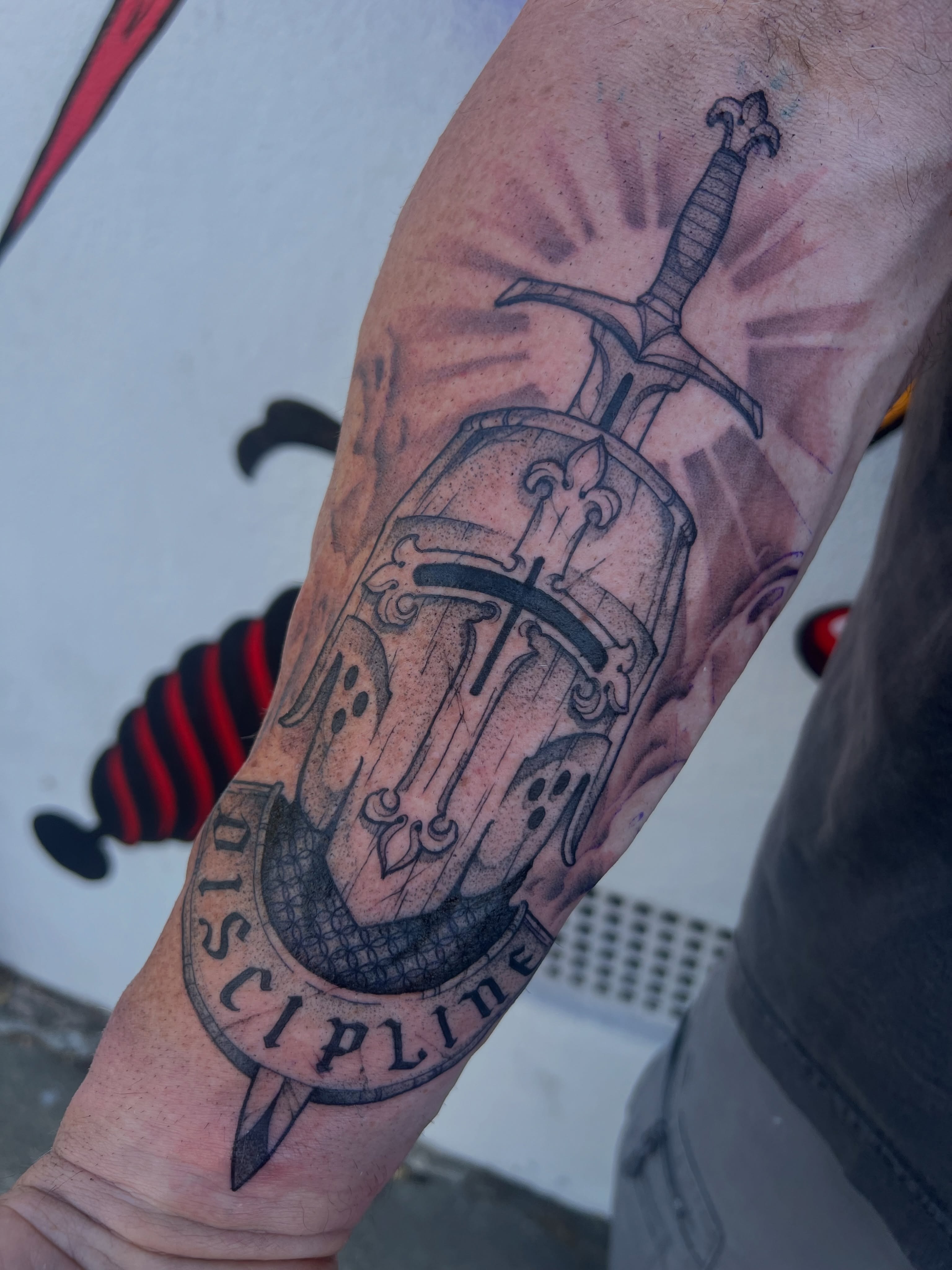 Shield and sword black and grey tattoo on the forearm by Owen Smith -OEOS- SF