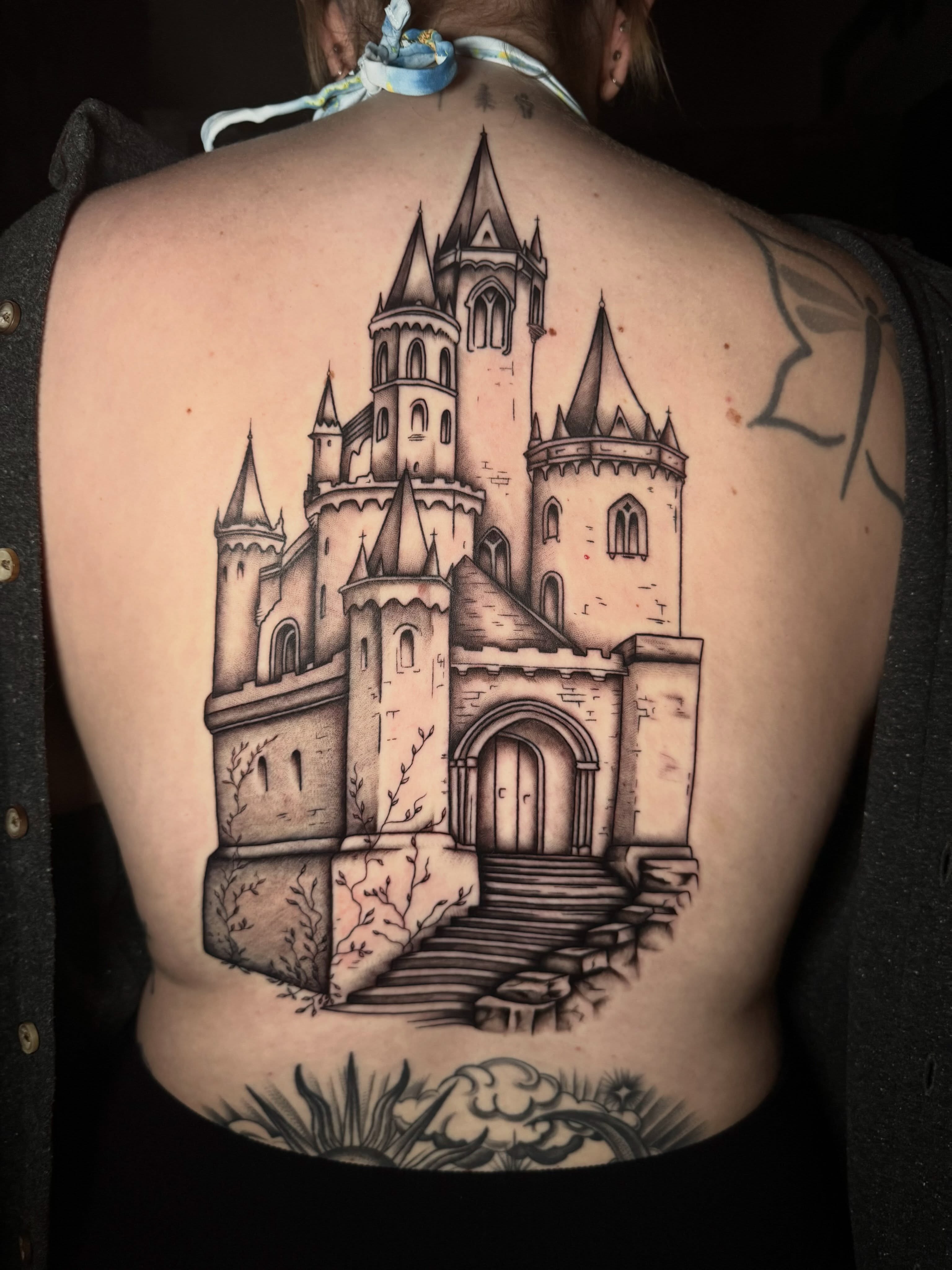 Castle black and grey tattoo on the back by oh hey, robin.