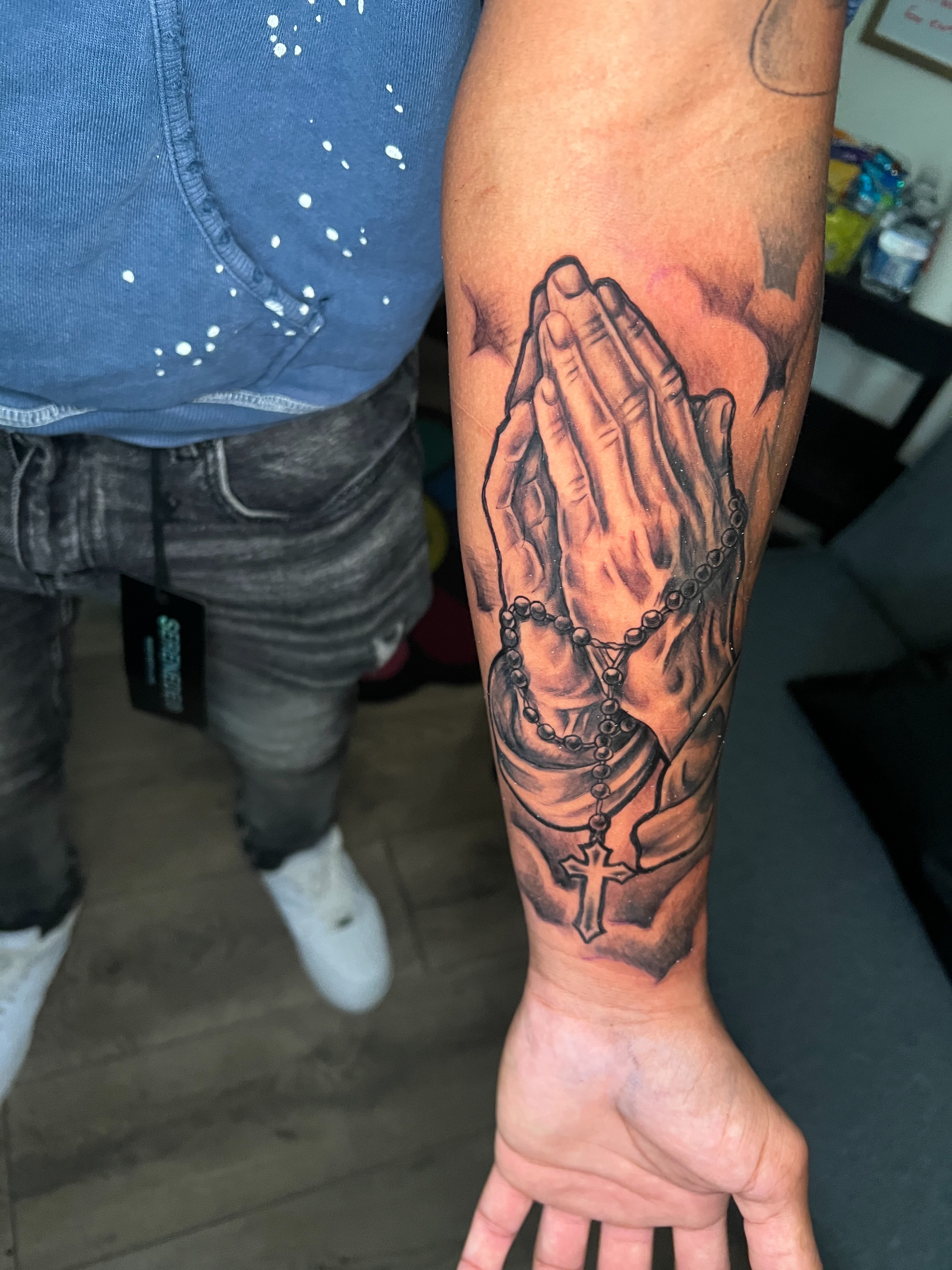 Praying hands with rosary realism tattoo on the forearm by Justx4rt