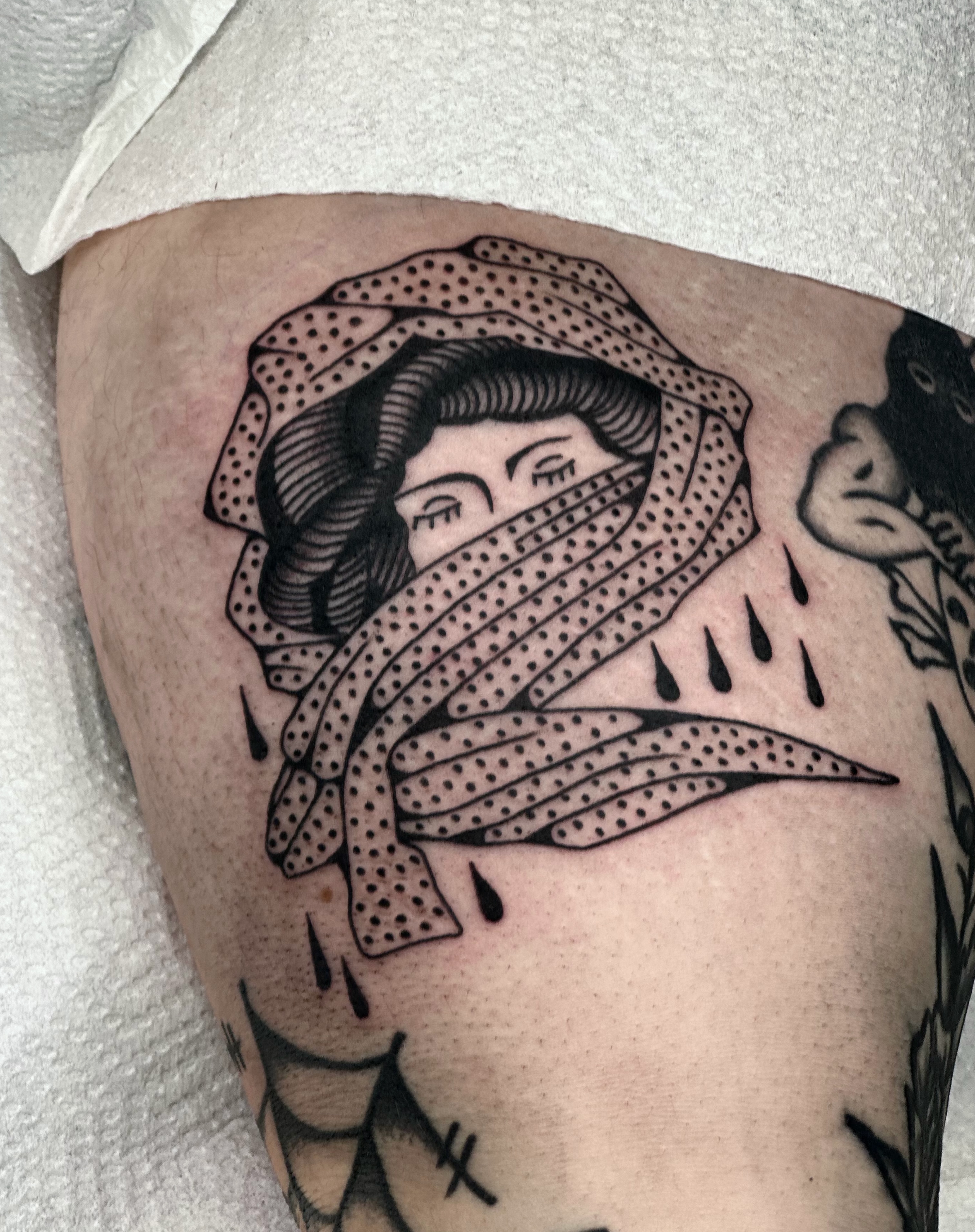 Woman with scarf dotwork tattoo on the thigh by Maks