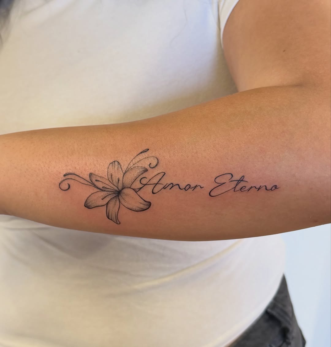 Flower and script black and grey tattoo on the forearm by Sienna (jj) Hicks