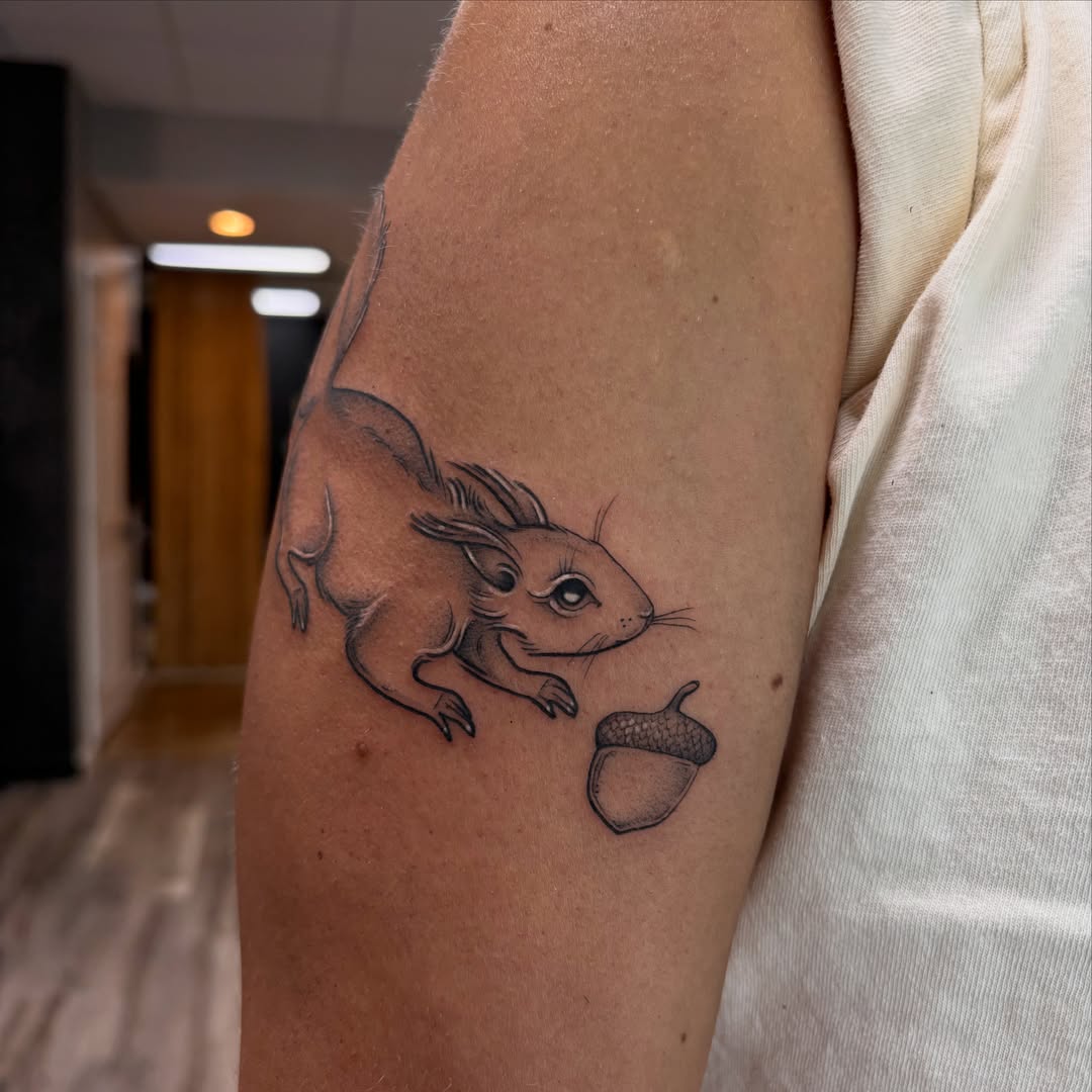 Squirrel and acorn realism tattoo on the forearm by Hailey Nicole