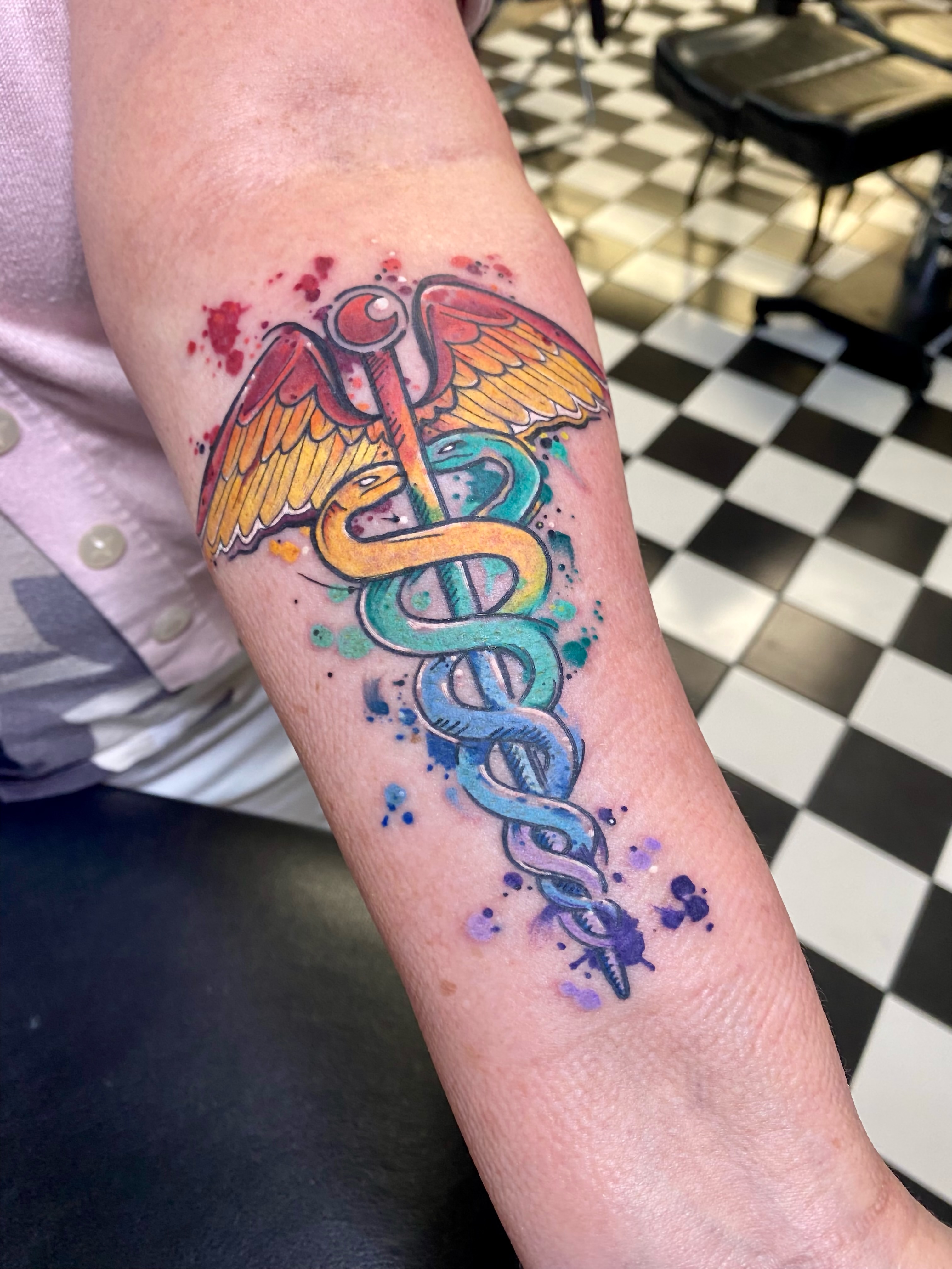 Caduceus new school tattoo on the forearm by Nick Weaver