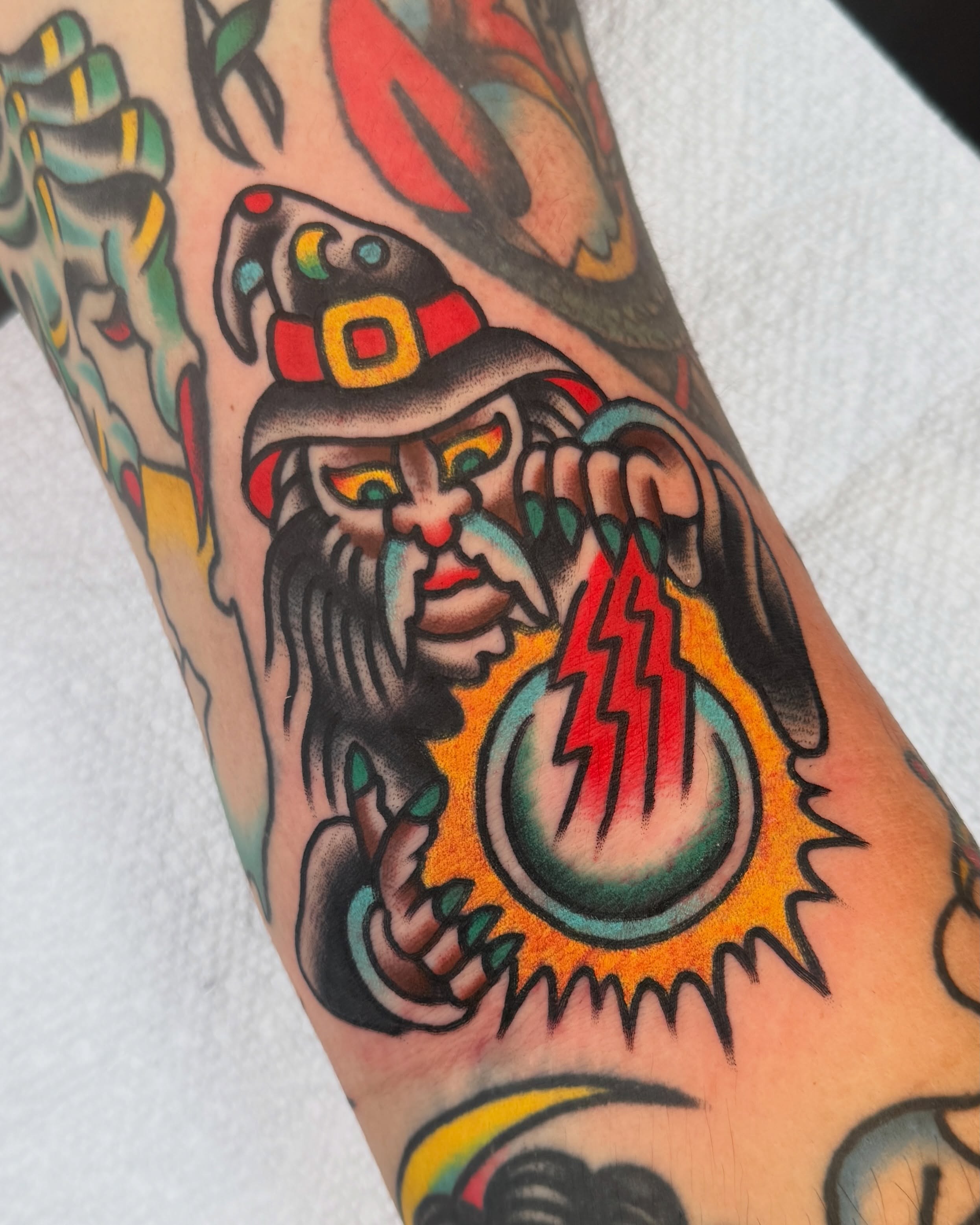 Wizard with lightning ball American traditional tattoo on the forearm by Cullen Bleser Quinn