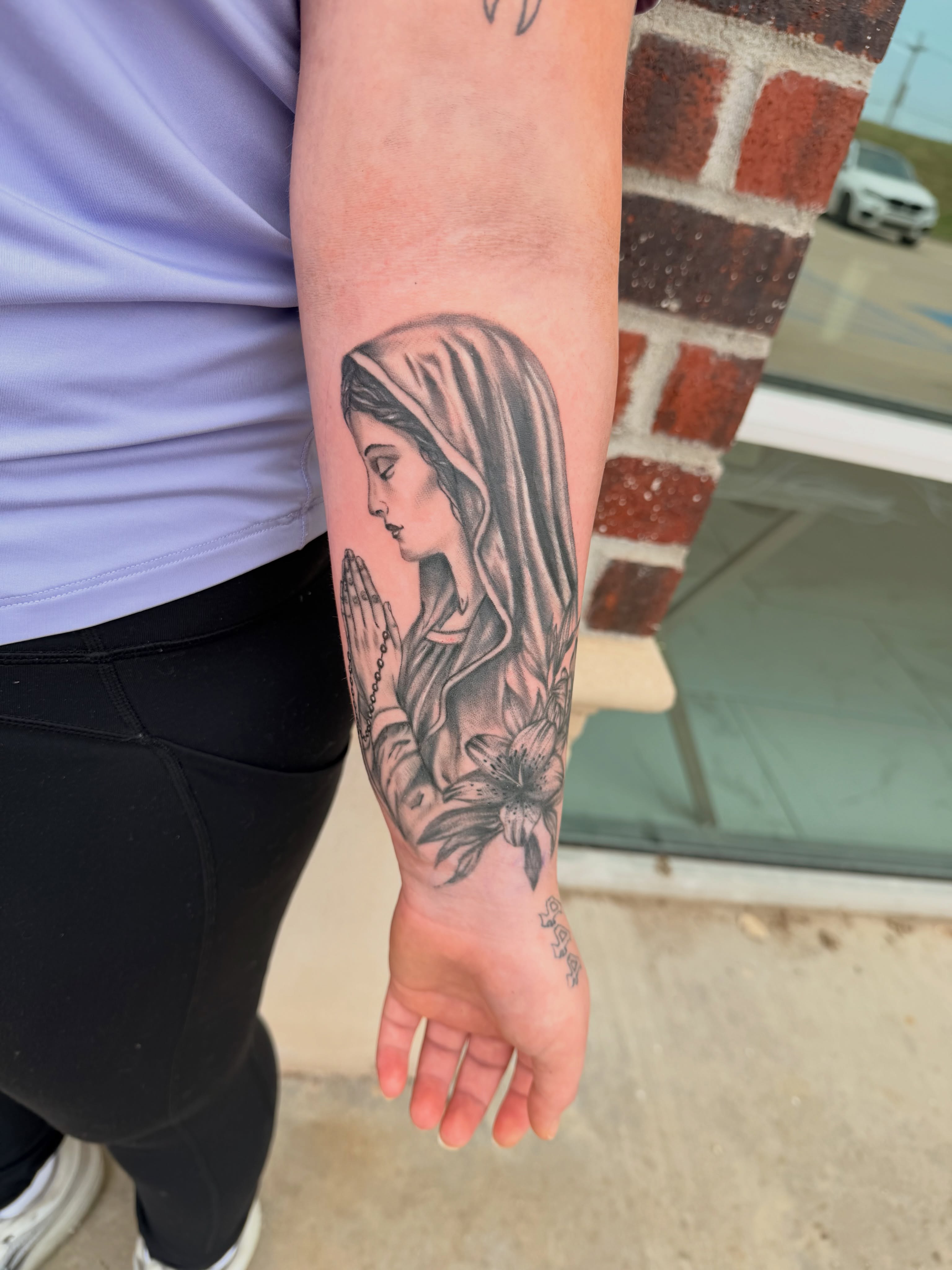 Religious figure realism tattoo on the forearm by Lexi Odam