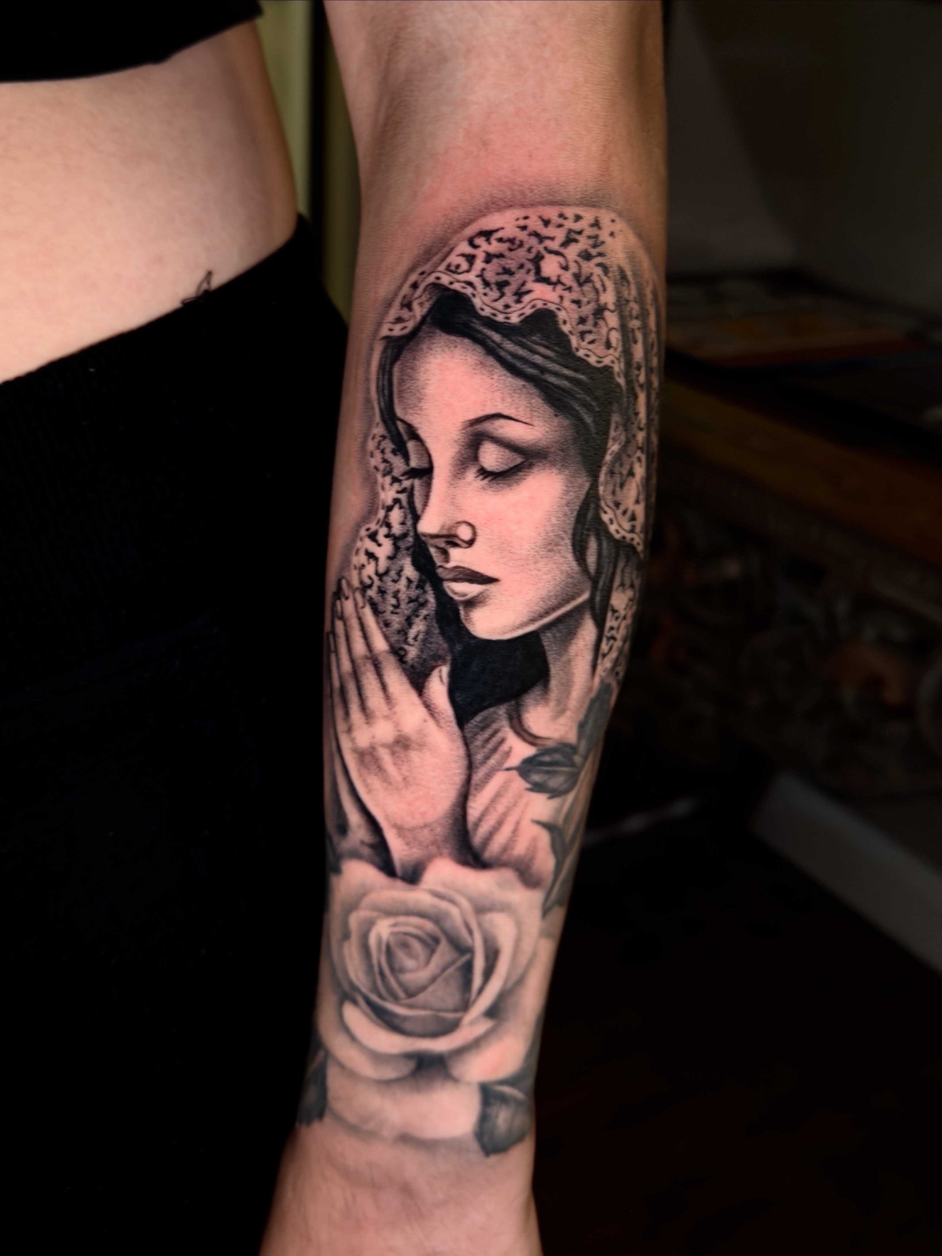Praying woman realism tattoo on the forearm by Marisa Biddle