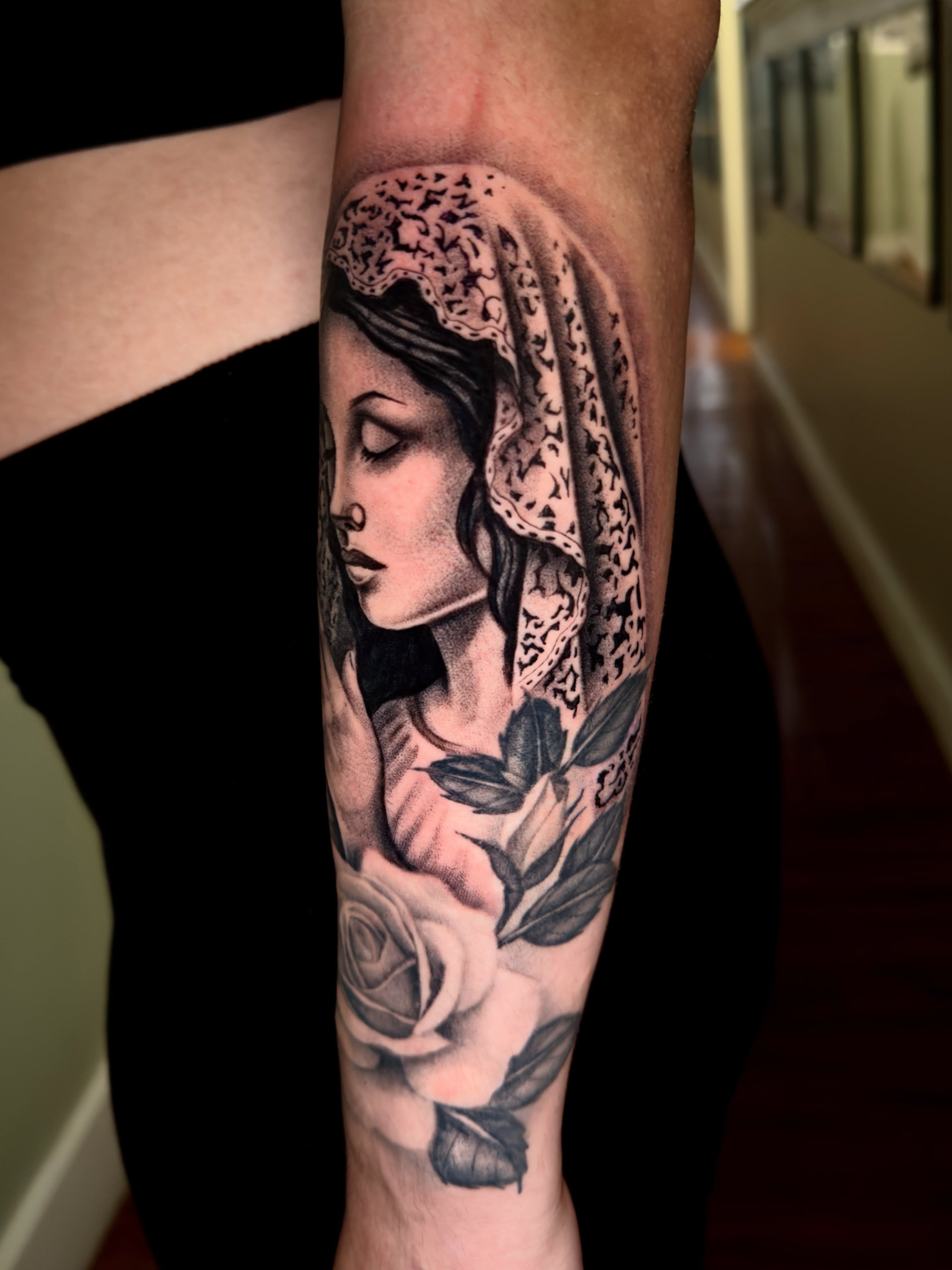Woman with veil realism tattoo on the forearm by Marisa Biddle