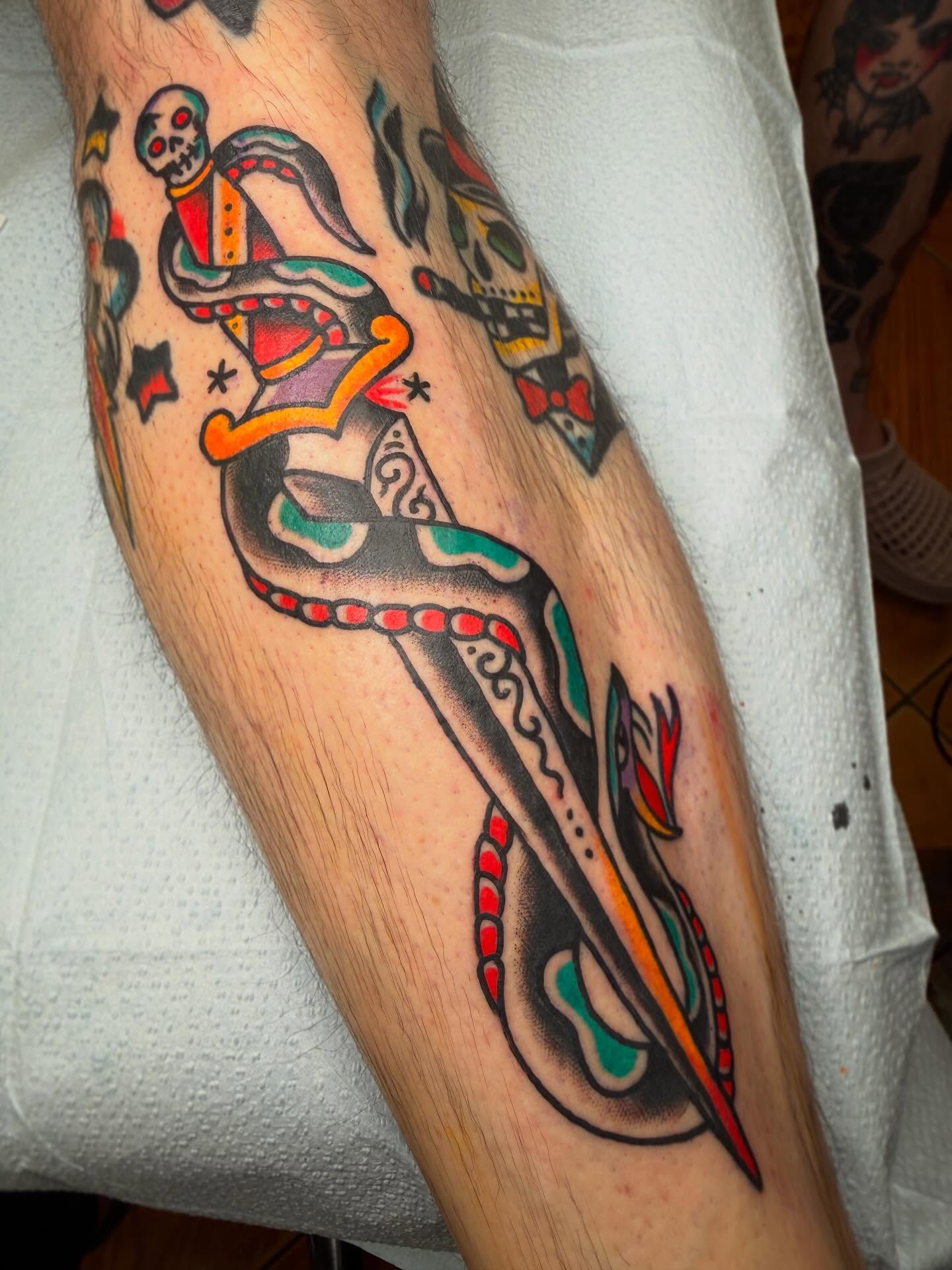 Snake and dagger American traditional tattoo on the forearm by Mike Wilson
