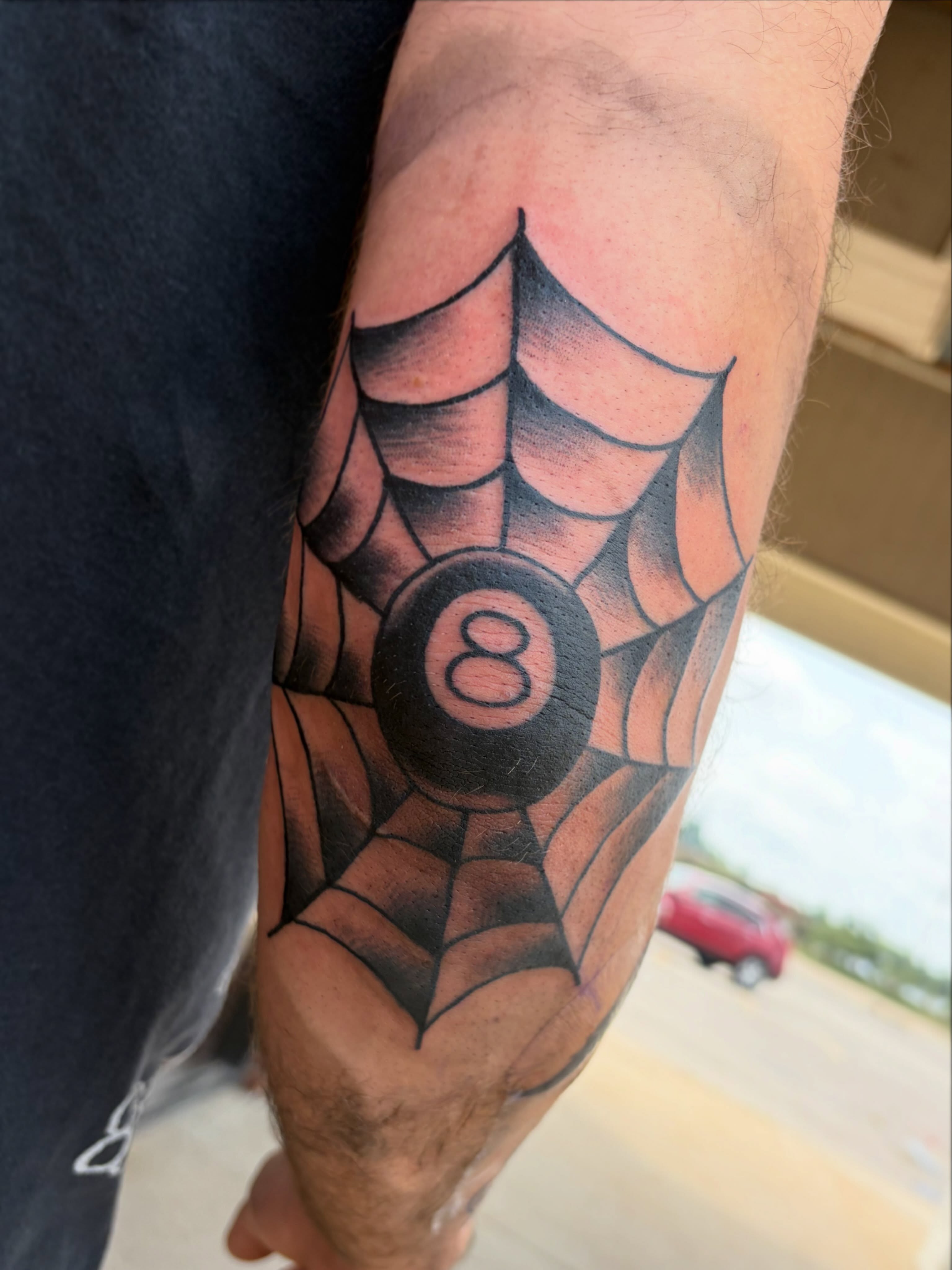 Spiderweb with eight ball American traditional tattoo on the forearm by Morgan Hazer Tattoos, Cedar Rapids, Iowa