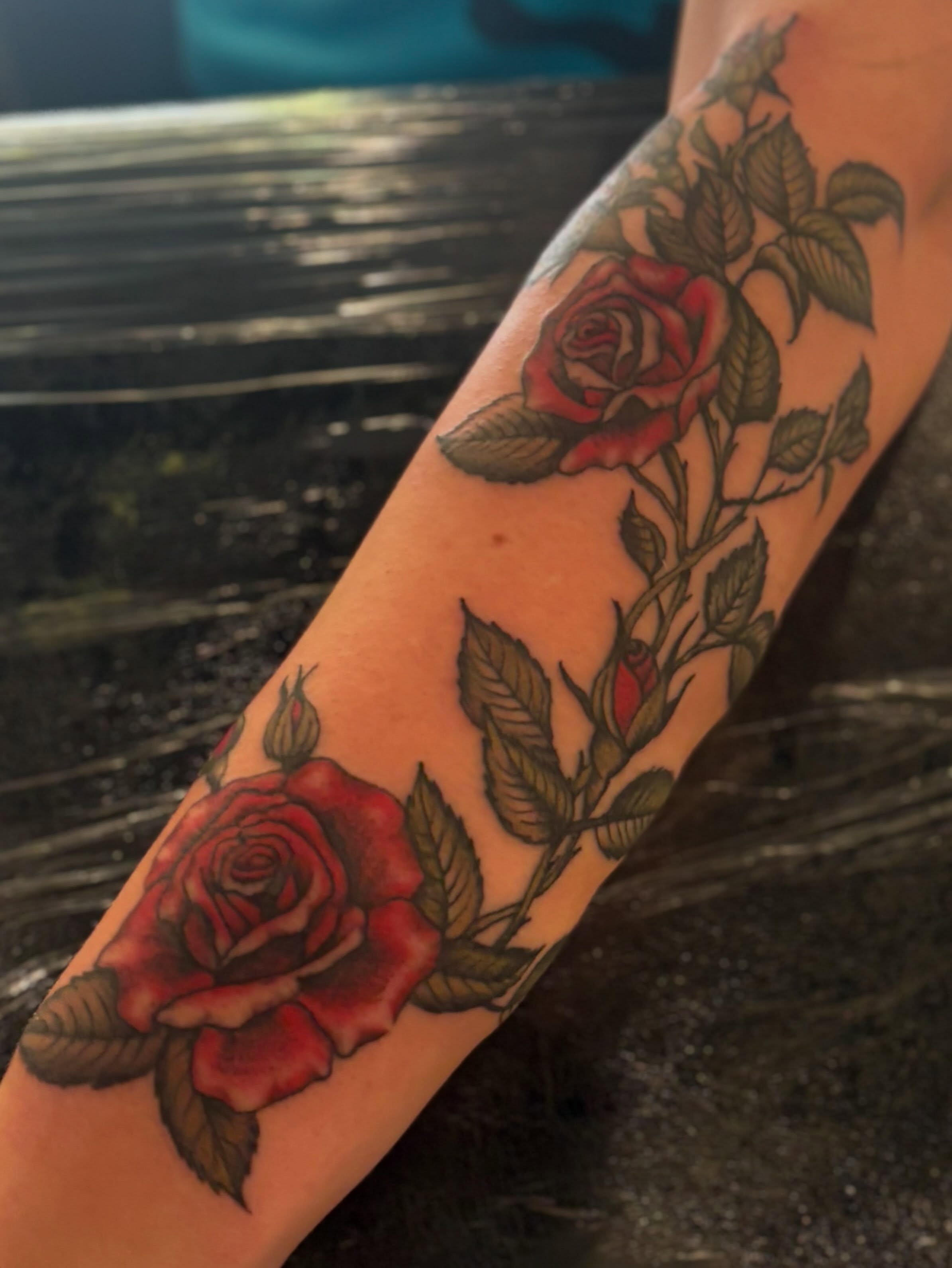 Roses American traditional tattoo on the forearm by Tia Cave