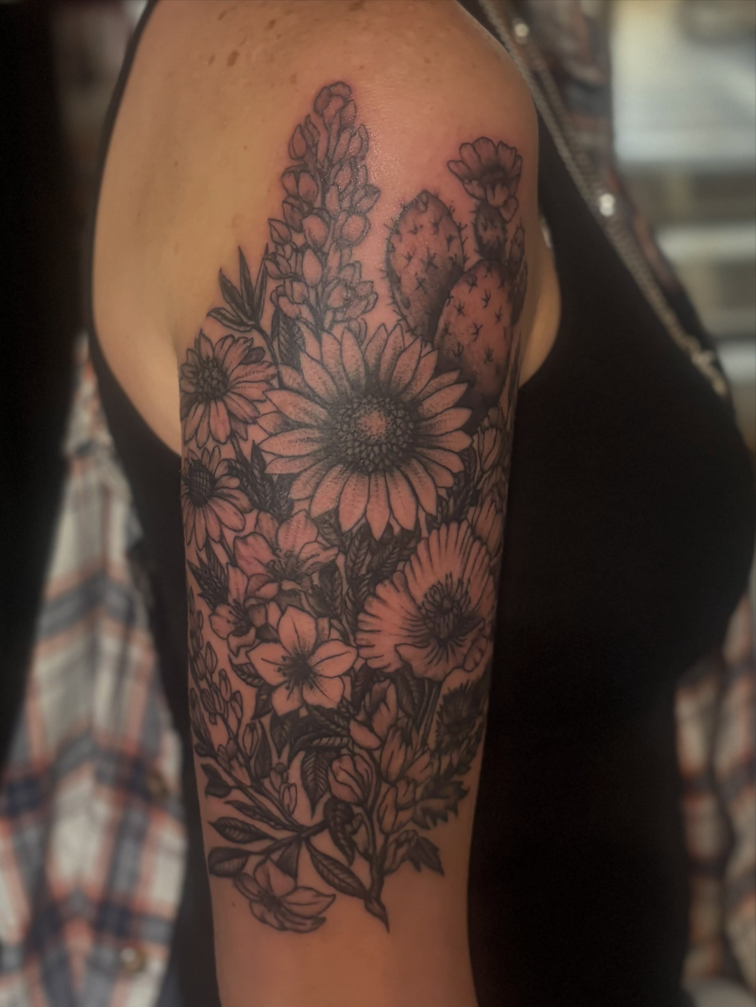 Floral bouquet black and grey tattoo on the forearm by Tia Cave