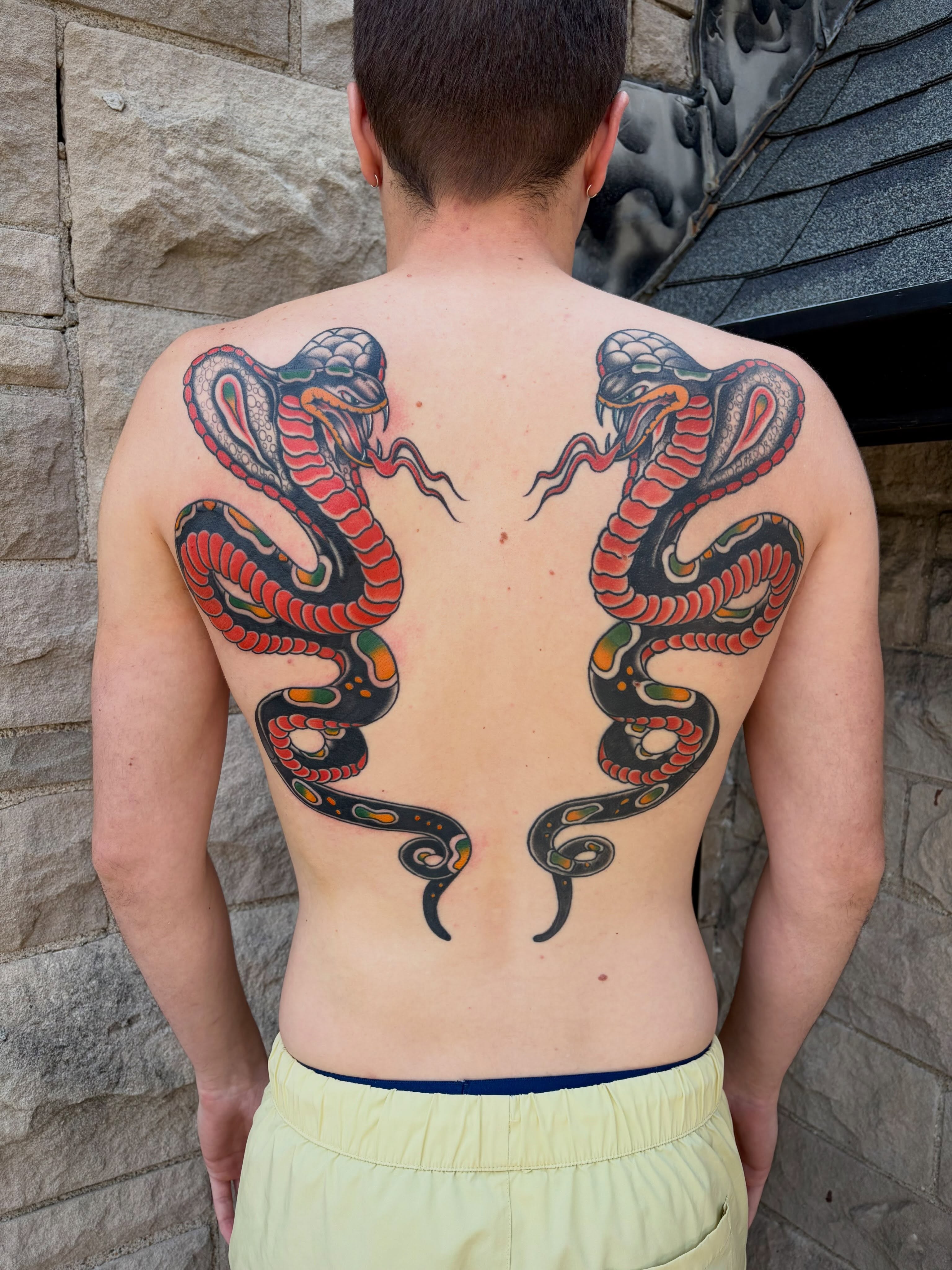 Snakes American traditional tattoo on the back by Micheal McGlinchey