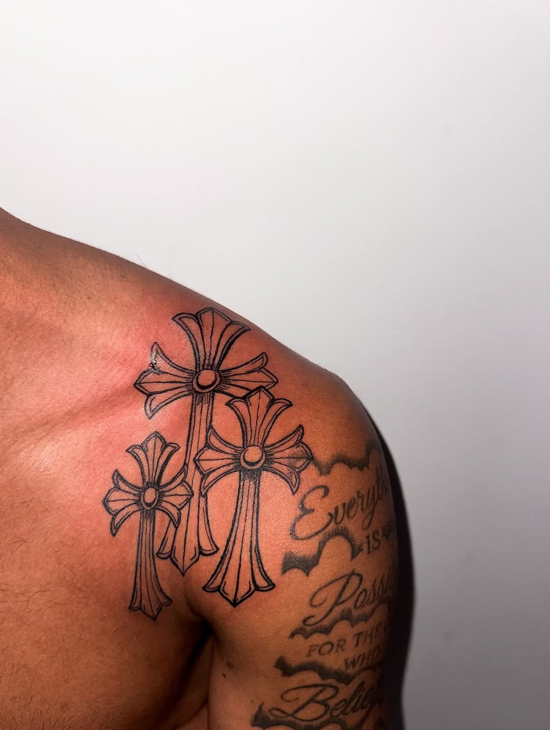 Three crosses tattoo on the shoulder by Comet