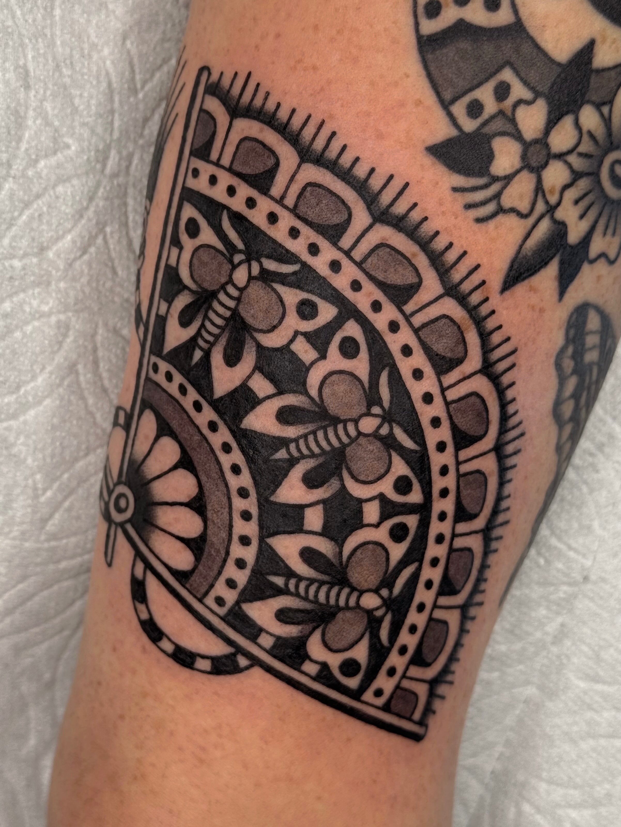 Floral mandala ornamental tattoo on the forearm by Bridgette Carberry