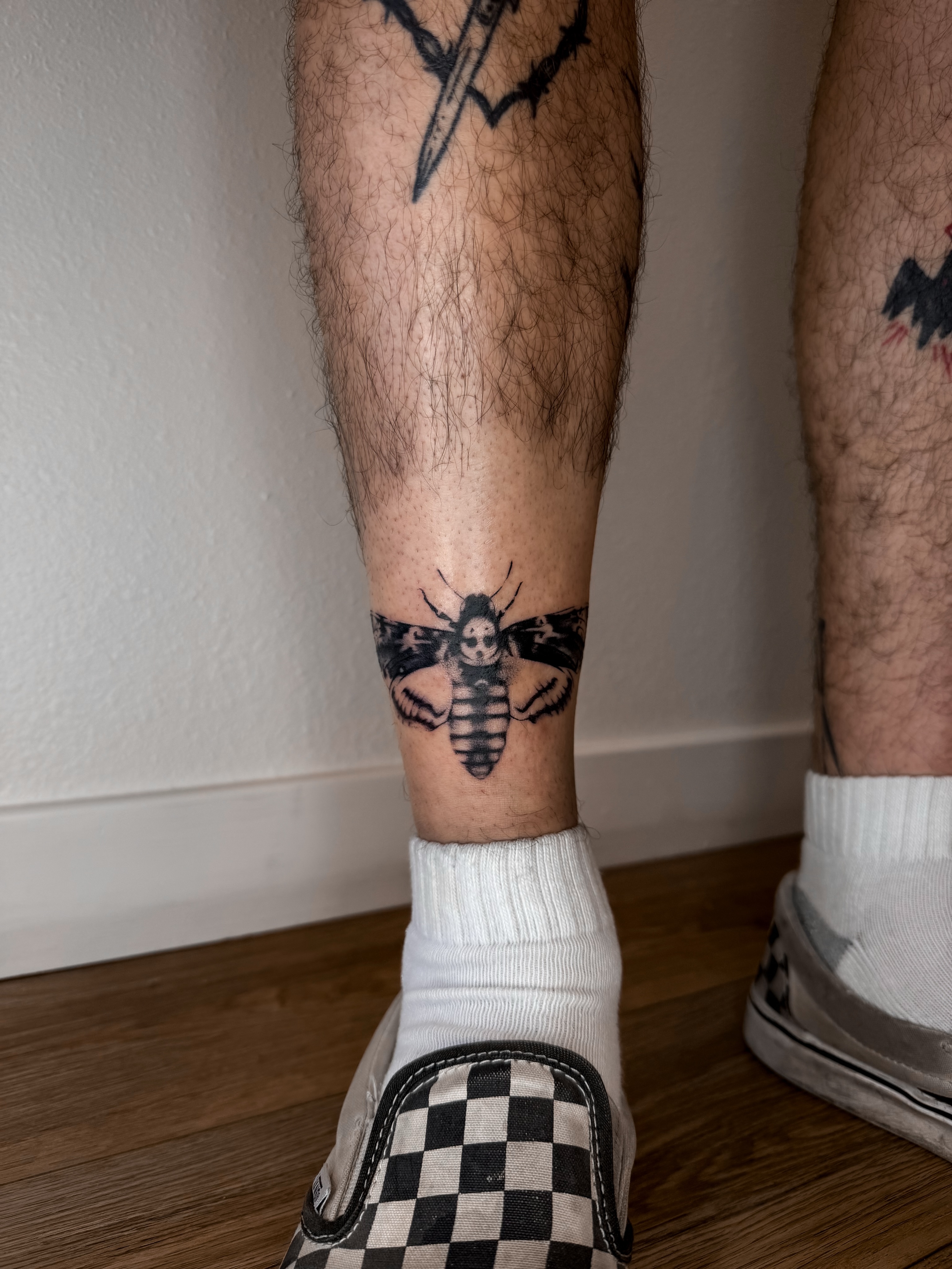 Bee black and grey tattoo on the calf by Rylee