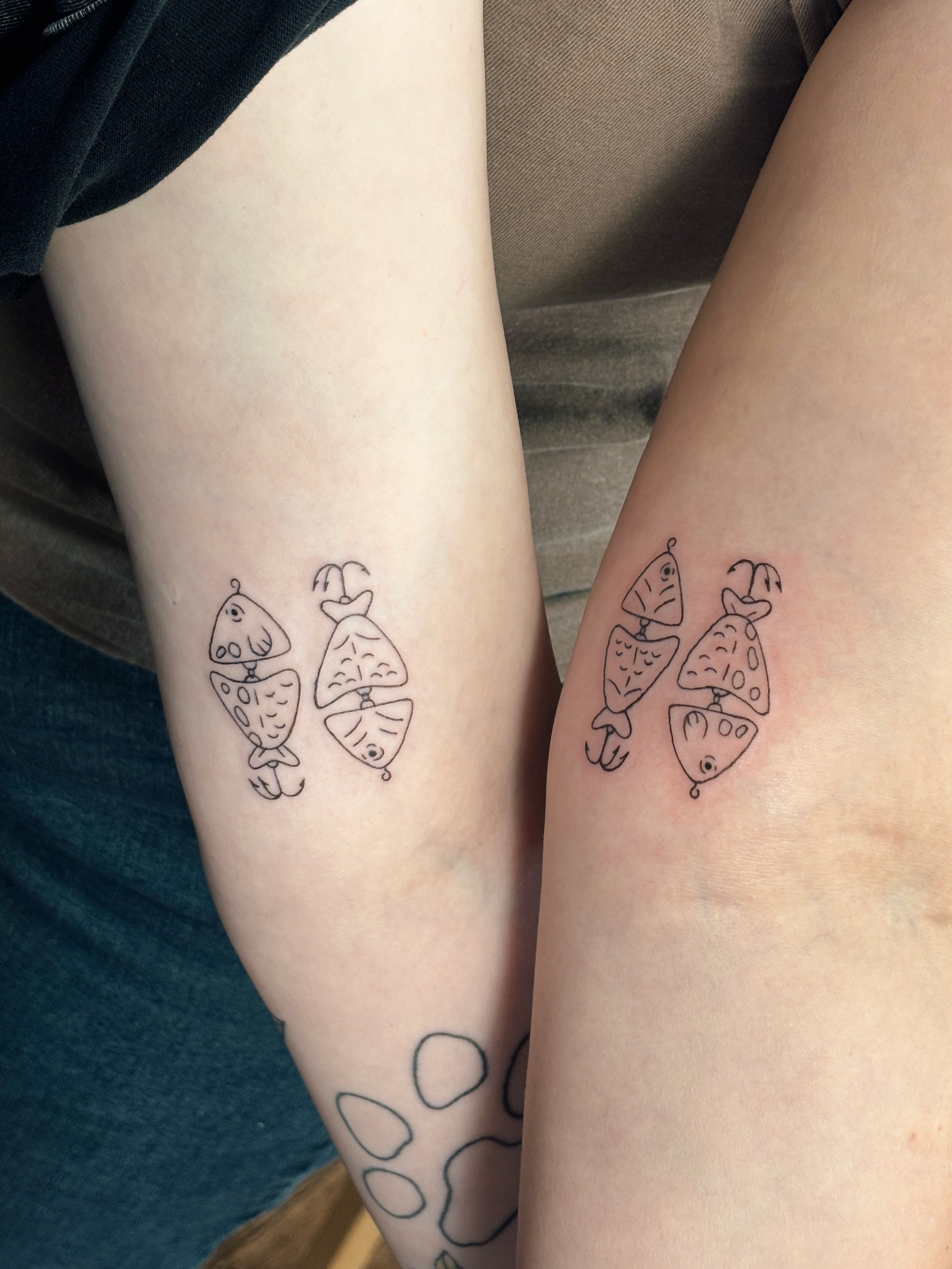 Fish minimalist tattoo on the forearm by Maddie