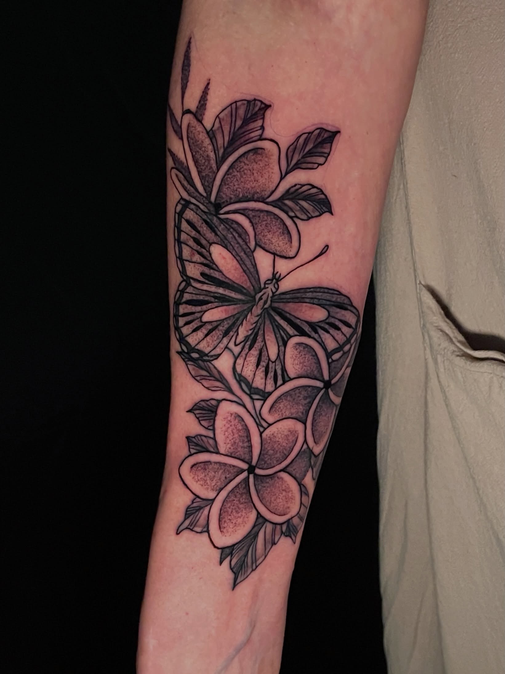 Butterfly and flowers dotwork tattoo on the forearm by Austin Clark