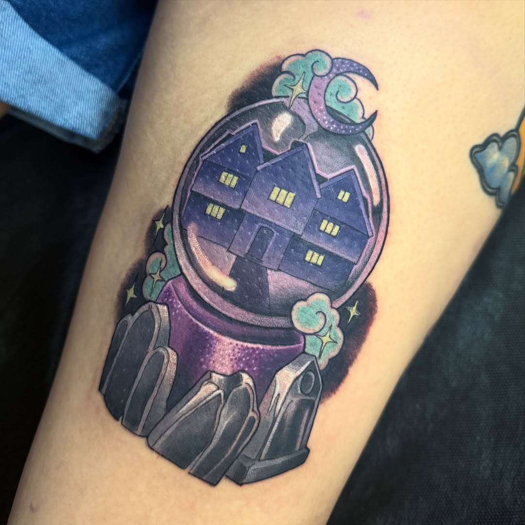 House in crystal ball American traditional tattoo on the thigh by Jessica Brown