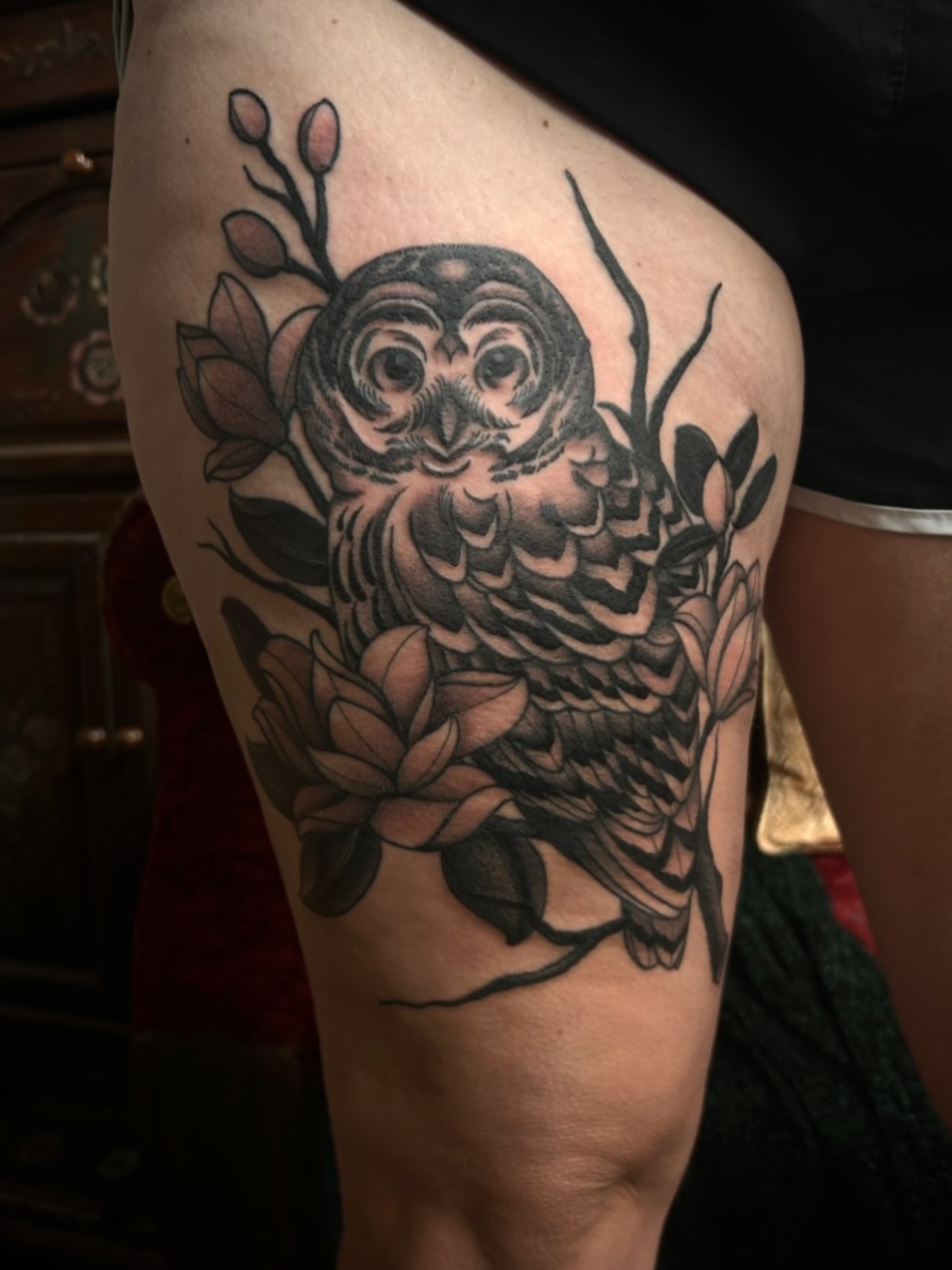 Owl and flowers black and grey tattoo on the thigh by ꧁𝙺𝚊𝚛𝚒𝚗𝚊꧂, Grinnell, Iowa