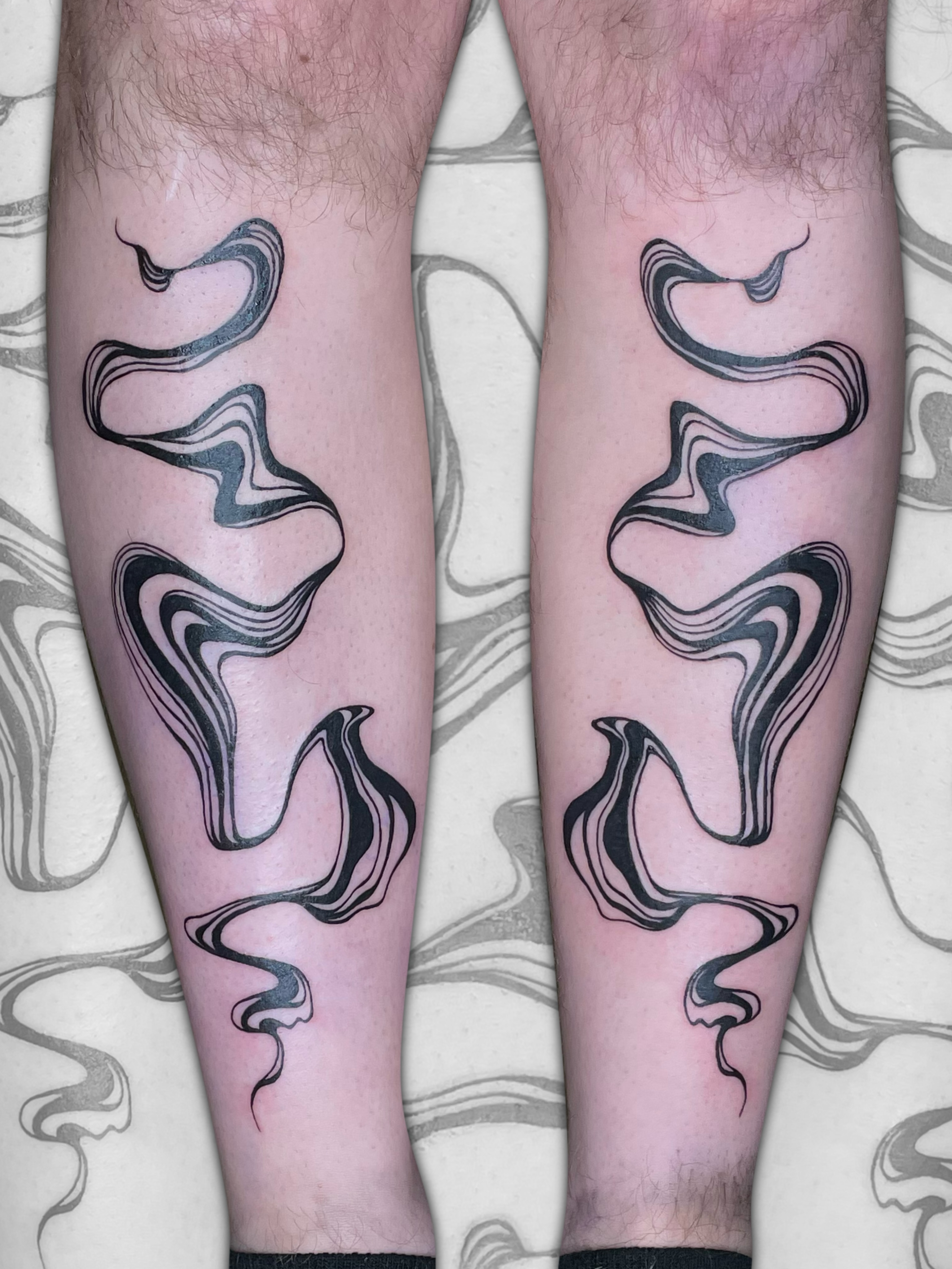 Abstract waves black and grey tattoo on the calf by Sydney “Goose “ Lange