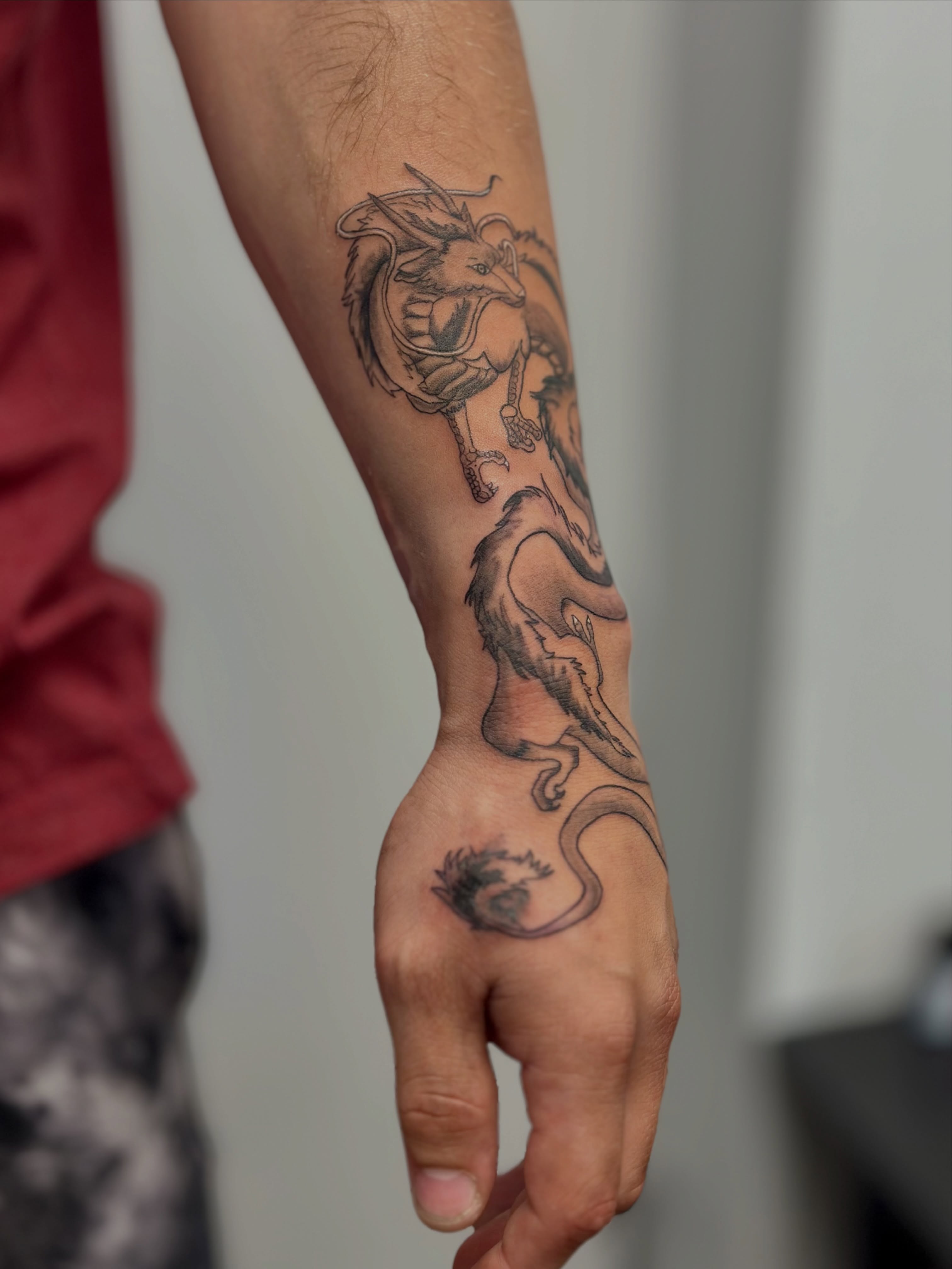 Dragon black and grey tattoo on the forearm by AJ
