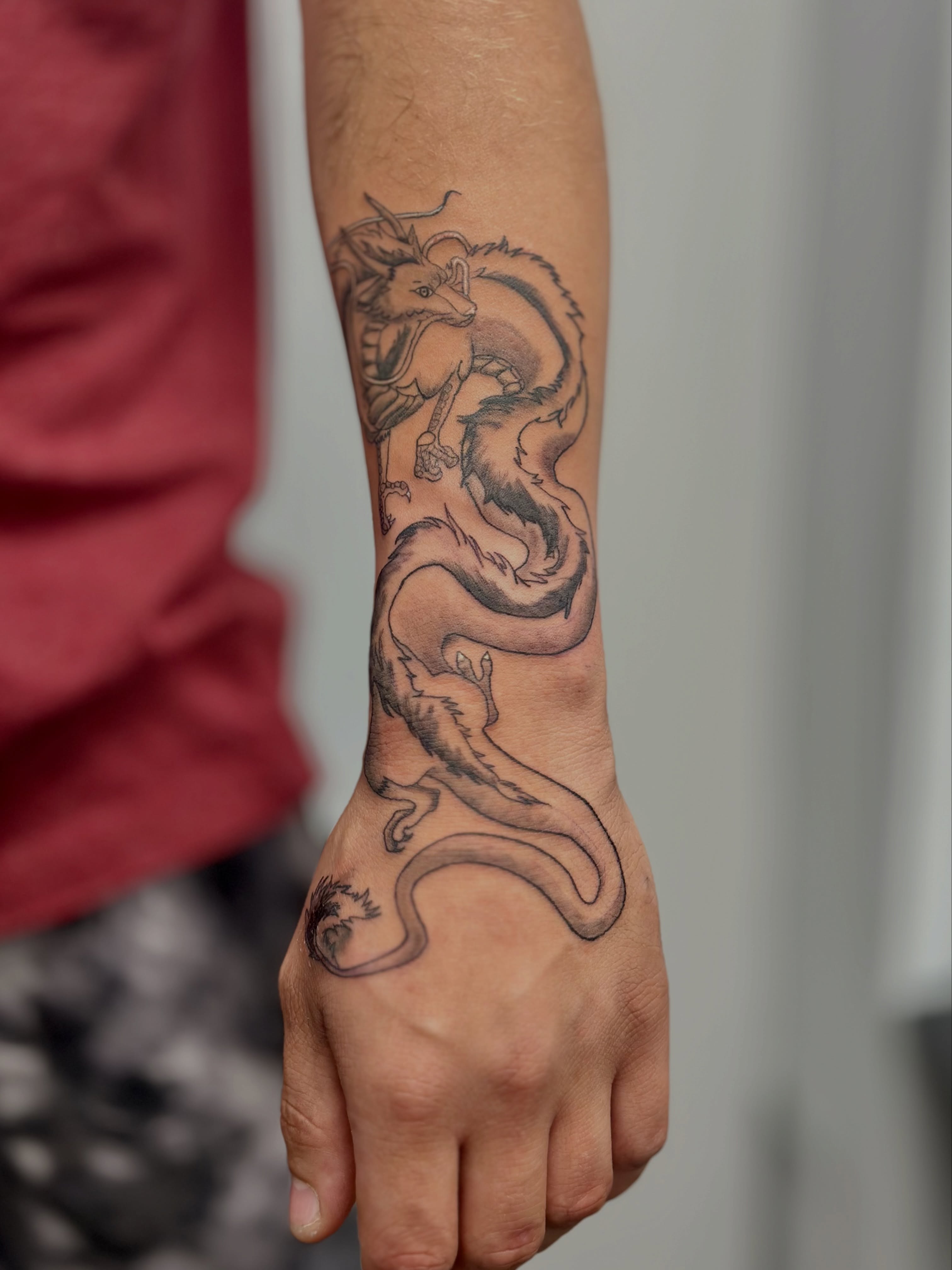 Dragon black and grey tattoo on the forearm by AJ