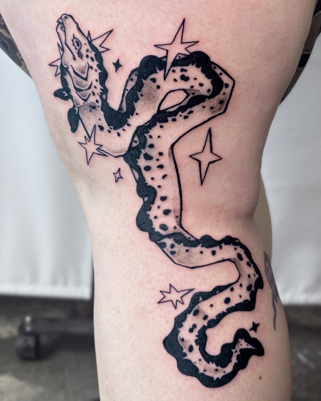 Snake black and grey tattoo on the thigh by Kal