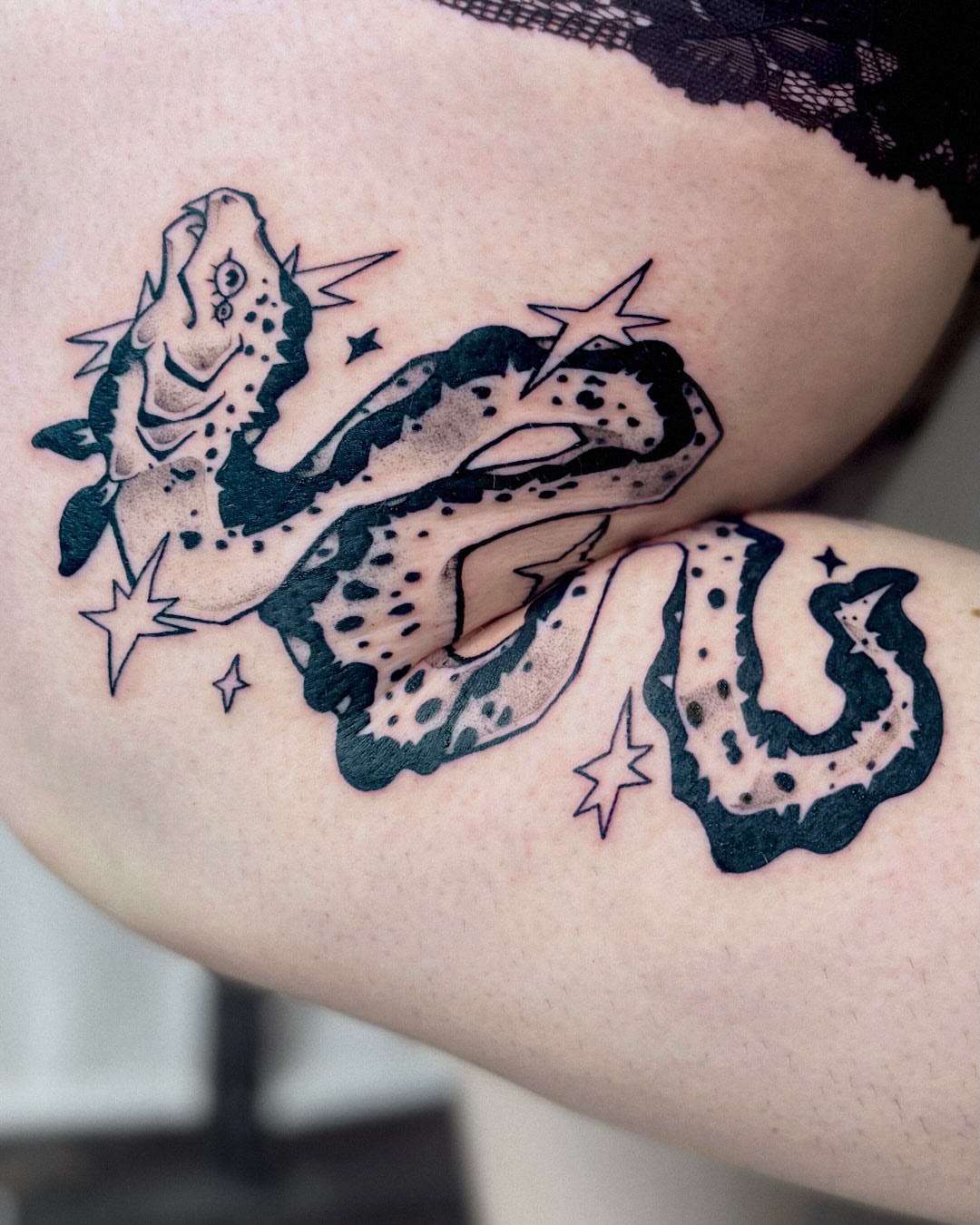 Snake black and grey tattoo on the upper arm by Kal