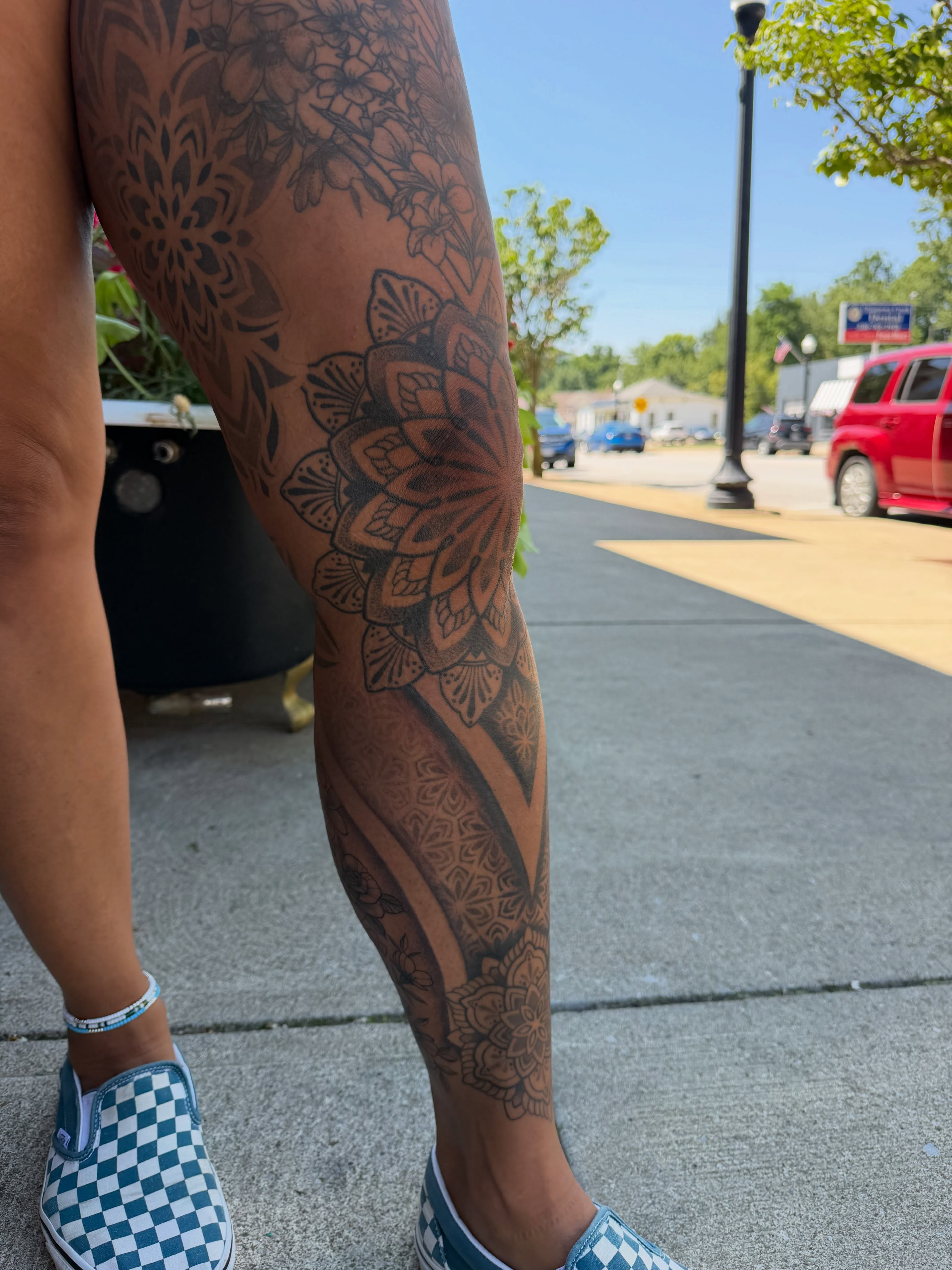 Floral mandala black and grey tattoo on the leg by Allison