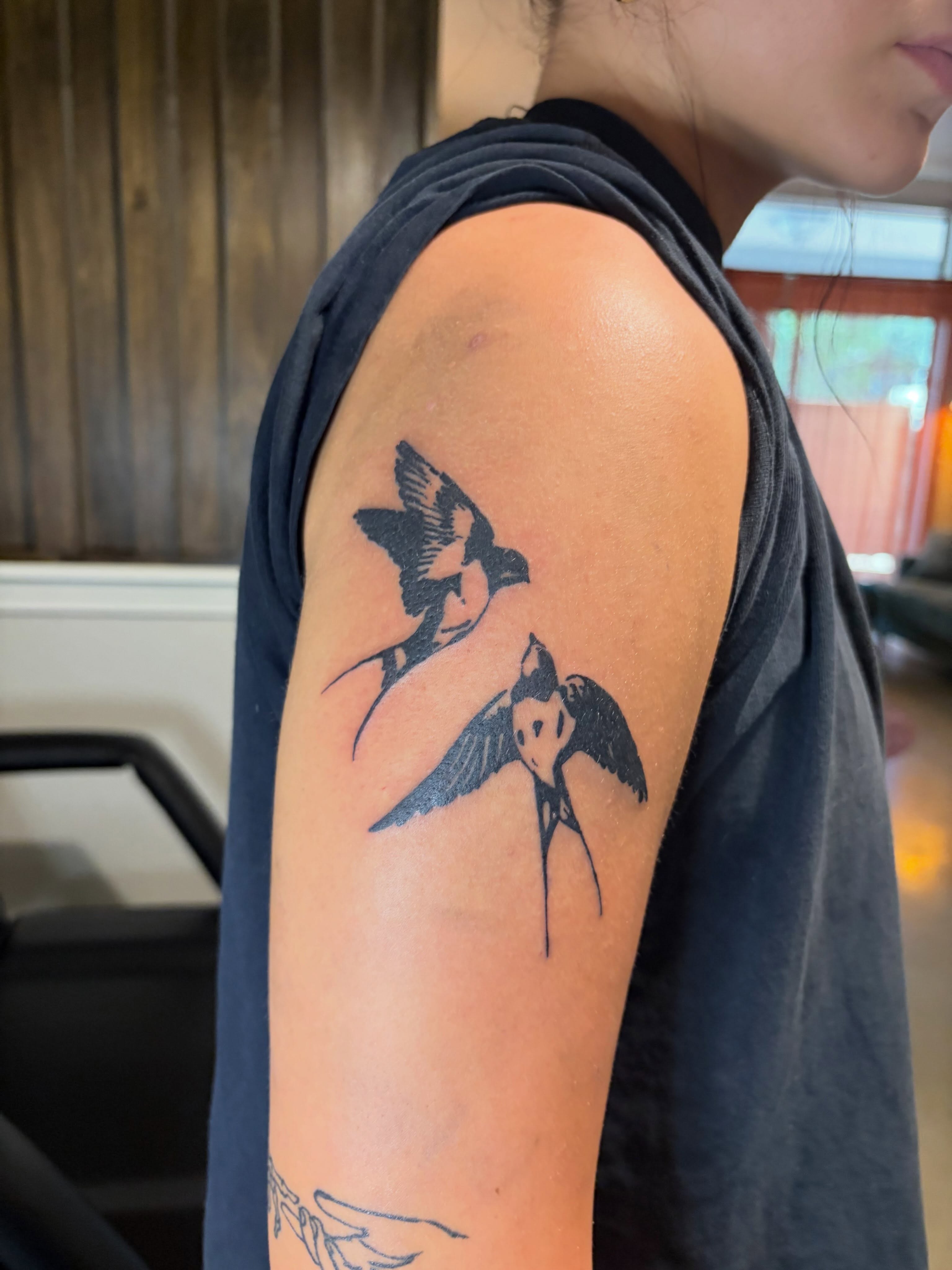 Swallows black and grey tattoo on the upper arm by blastedbybk