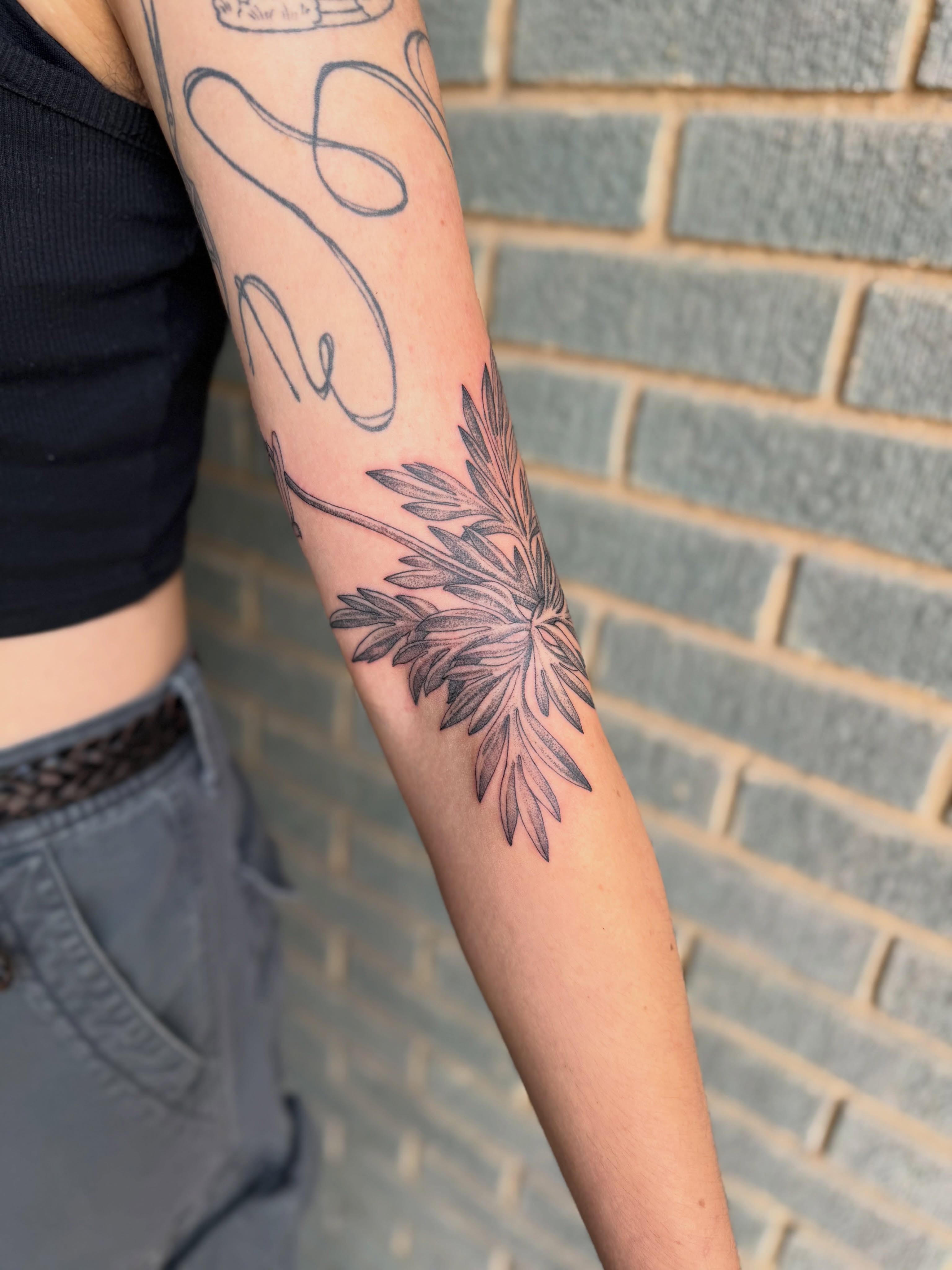 Flower black and grey tattoo on the forearm by Alex Brooke