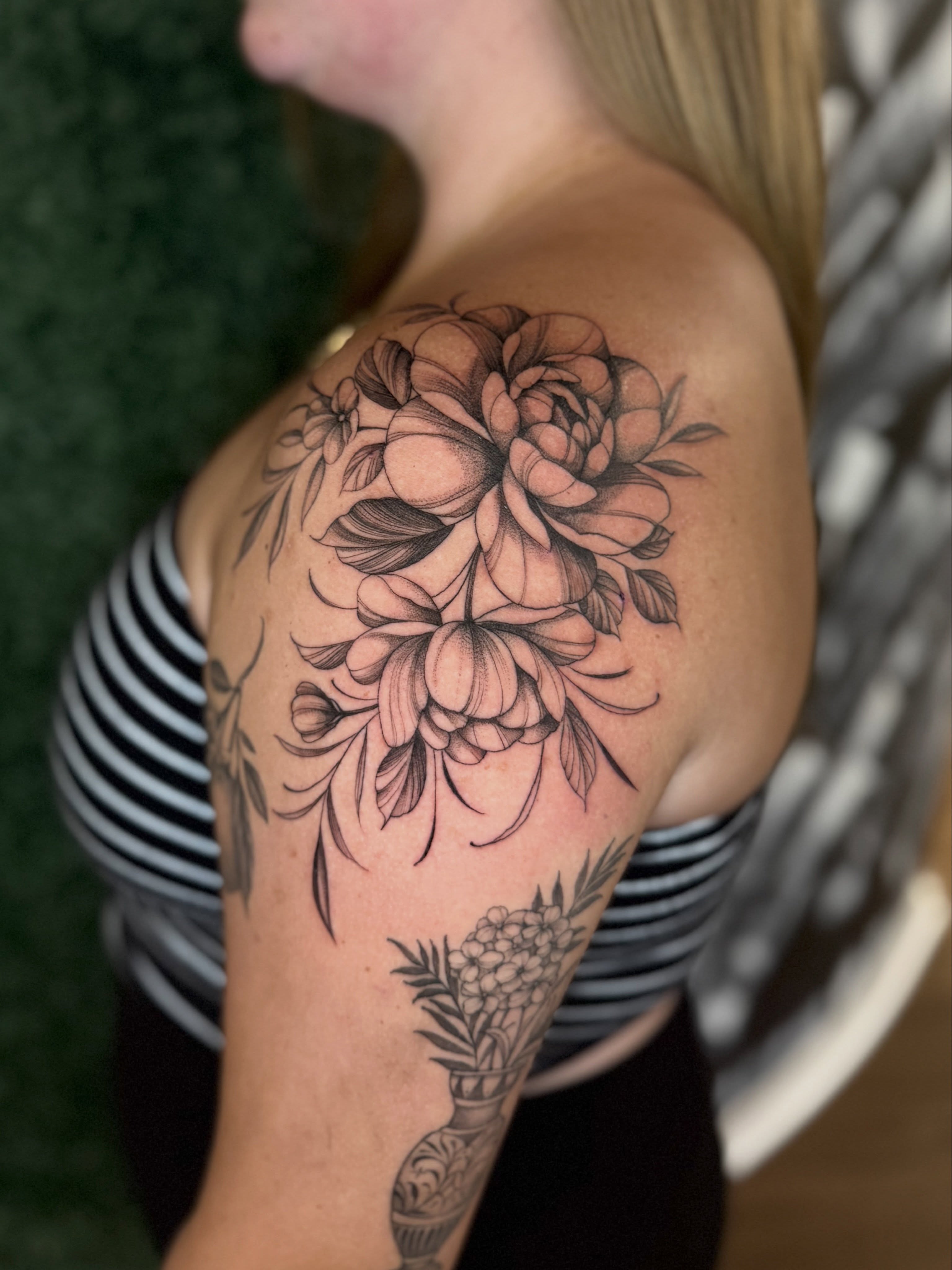 Floral bouquet black and grey tattoo on the shoulder by Chelsea Speirs