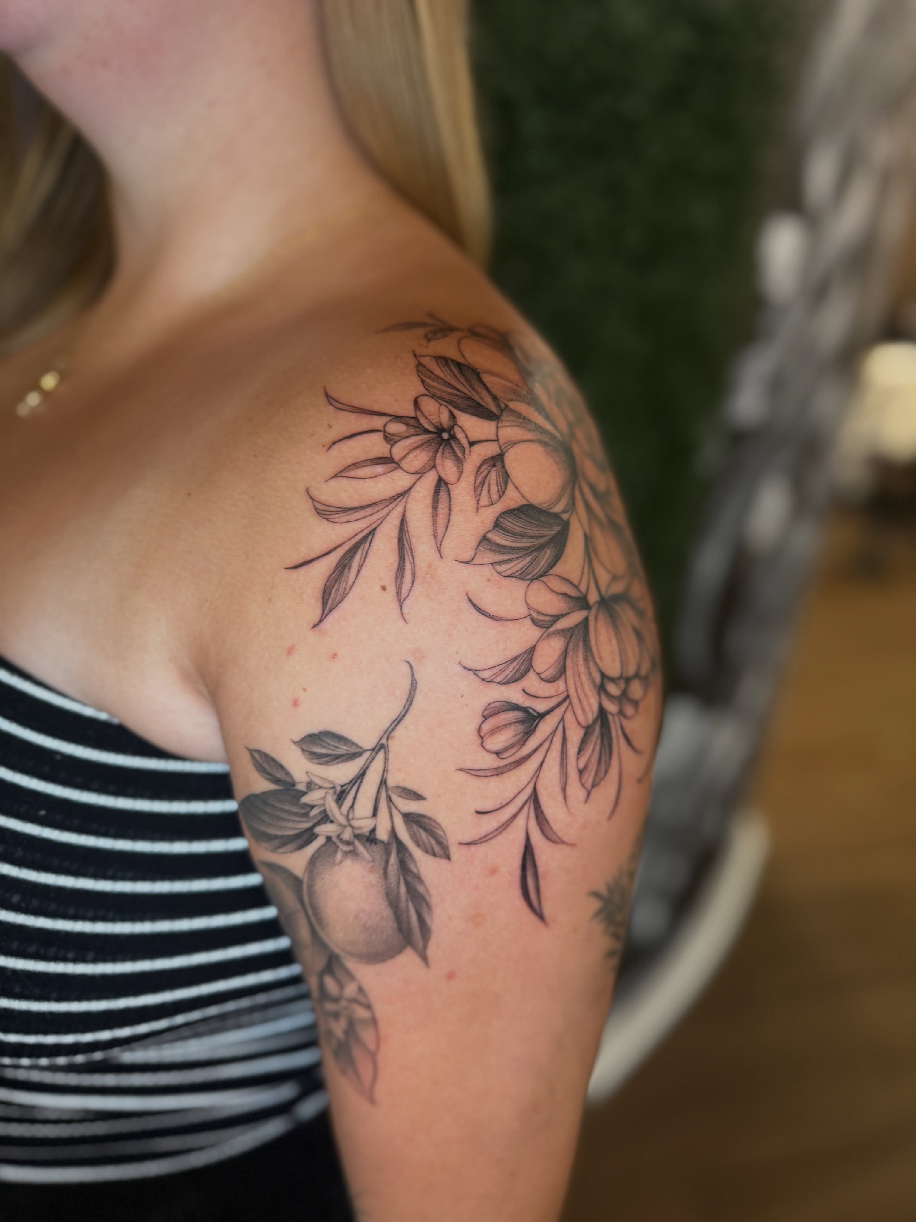 Floral arrangement black and grey tattoo on the shoulder by Chelsea Speirs