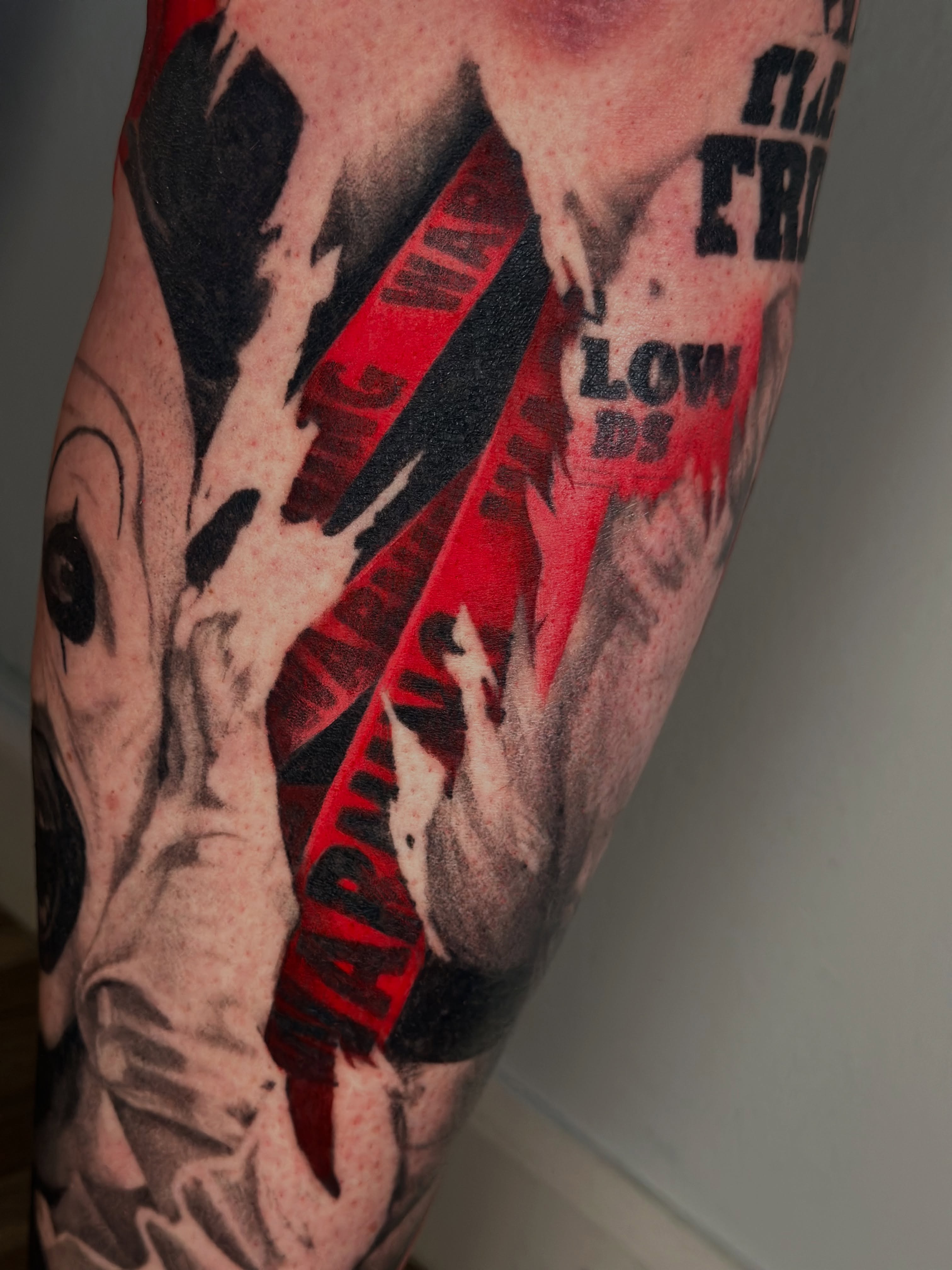 War propaganda poster black and grey tattoo on the forearm by Trent Hebert