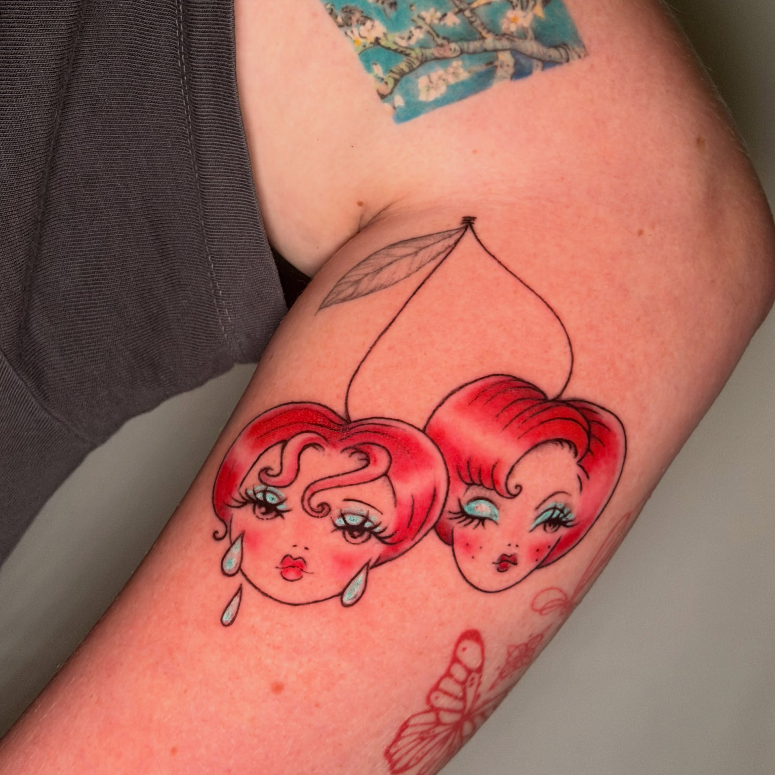 Cherry heads illustrative tattoo on the forearm by tattooz by megz