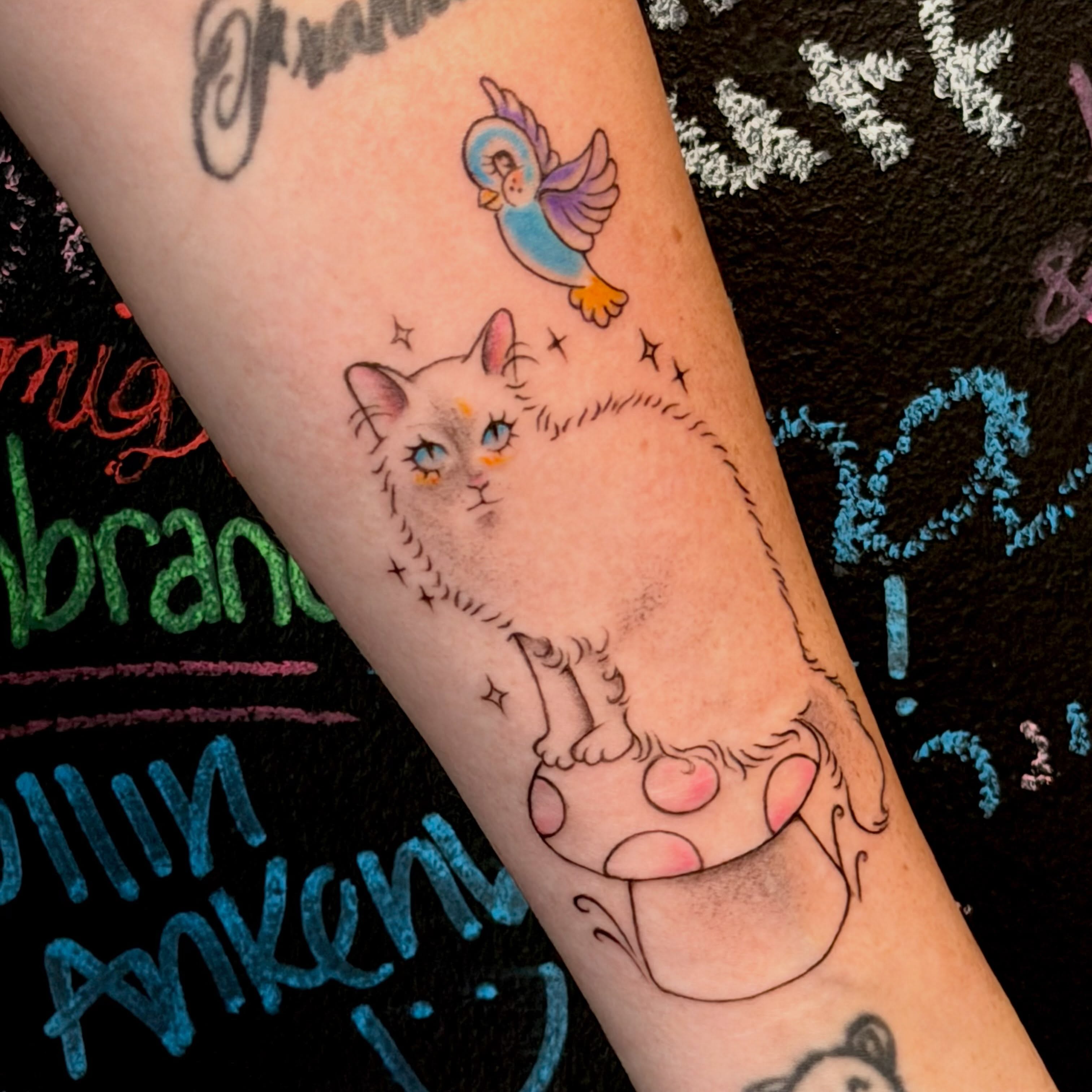 Cat and bird dotwork tattoo on the forearm by tattooz by megz
