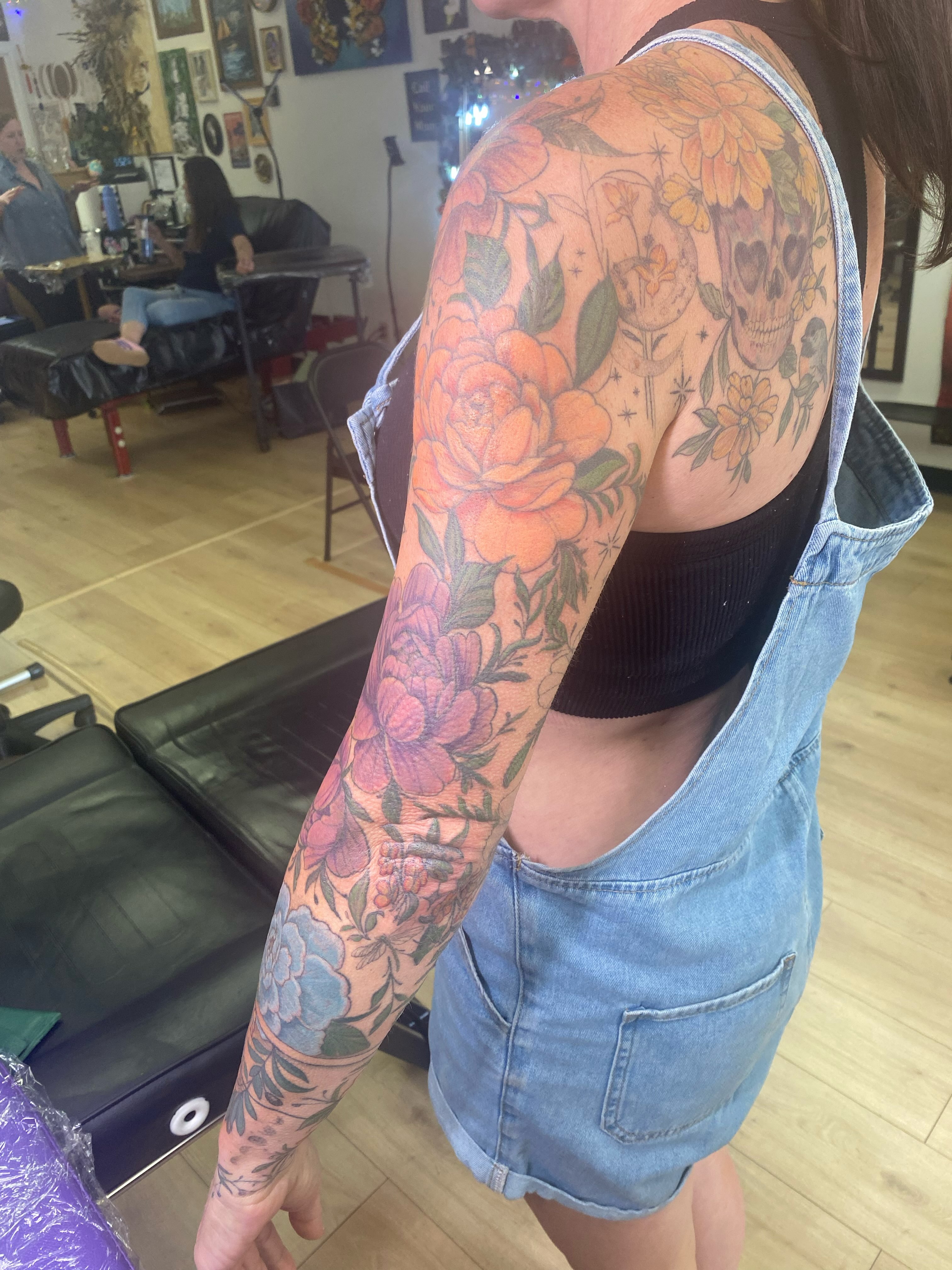 Floral sleeve American traditional tattoo on the upper arm by Katie Leeper